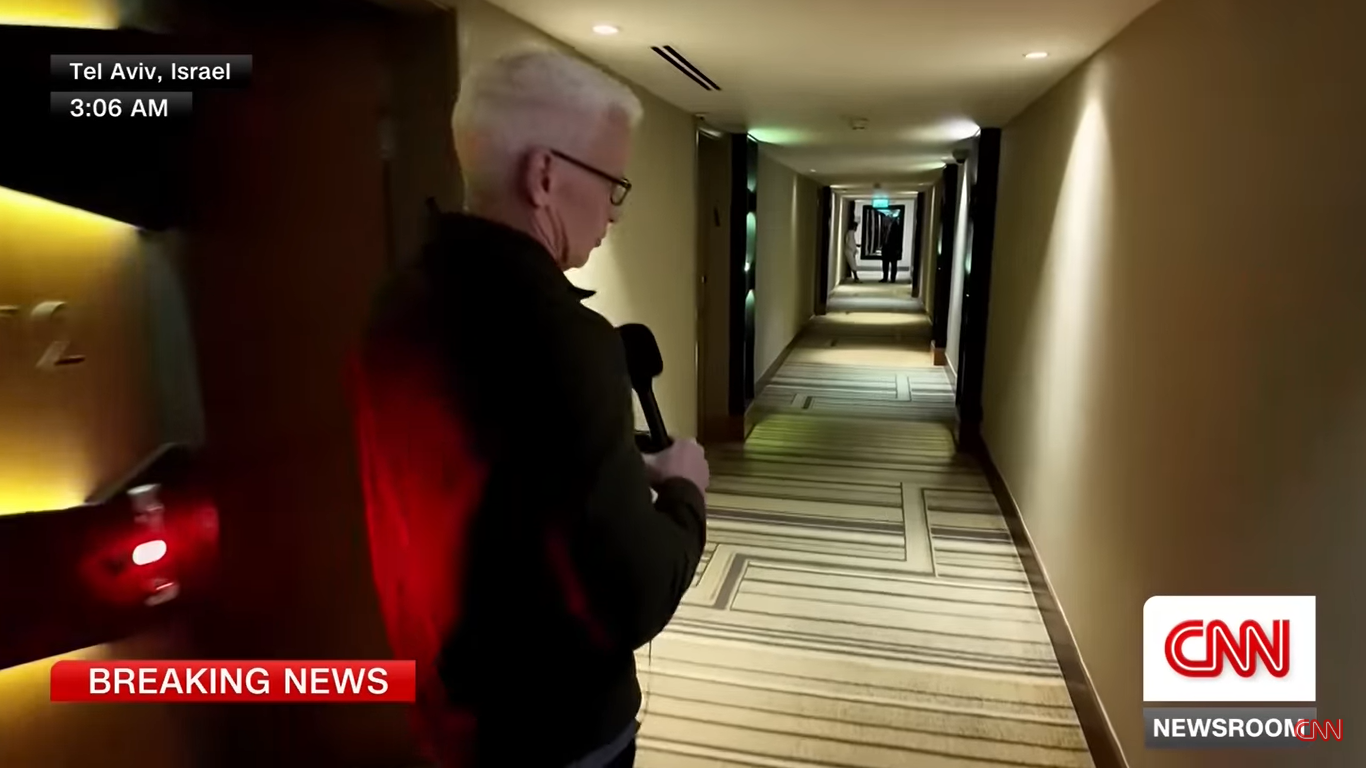 Anderson Cooper walks down the hallway during a live broadcast on June 23, 2025, in Tel Aviv, Israel. | Source: YouTube/CNN