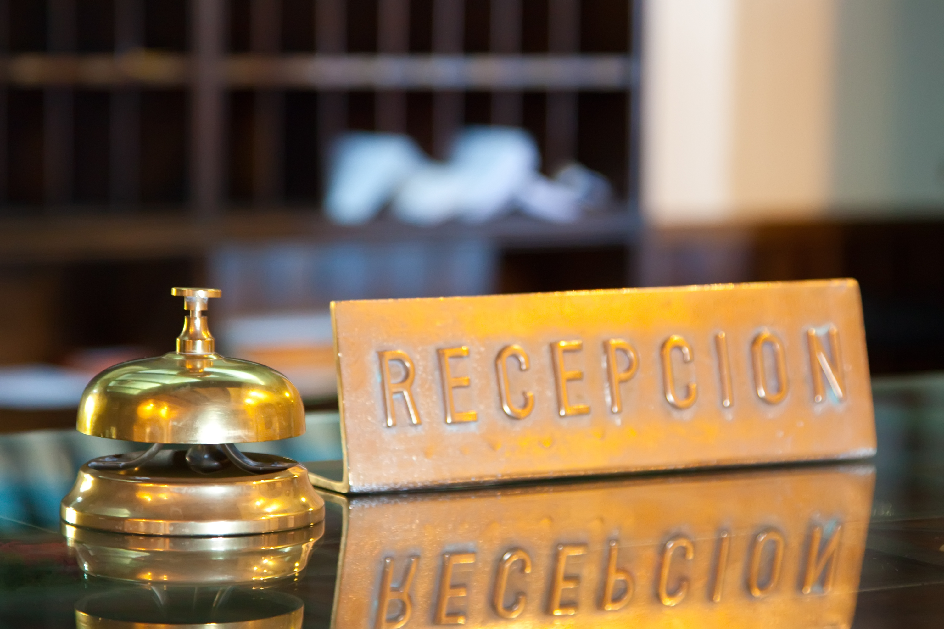 Bell on reception desk in motel. | Source: Shutterstock