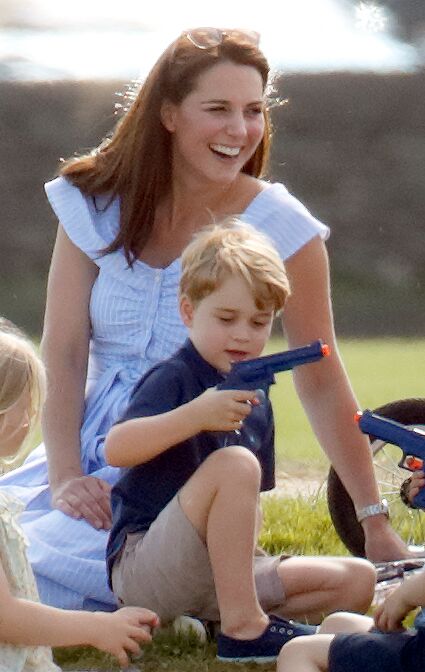 Kate Middleton looks on as Prince George plays with his toy. | Source: Getty Images