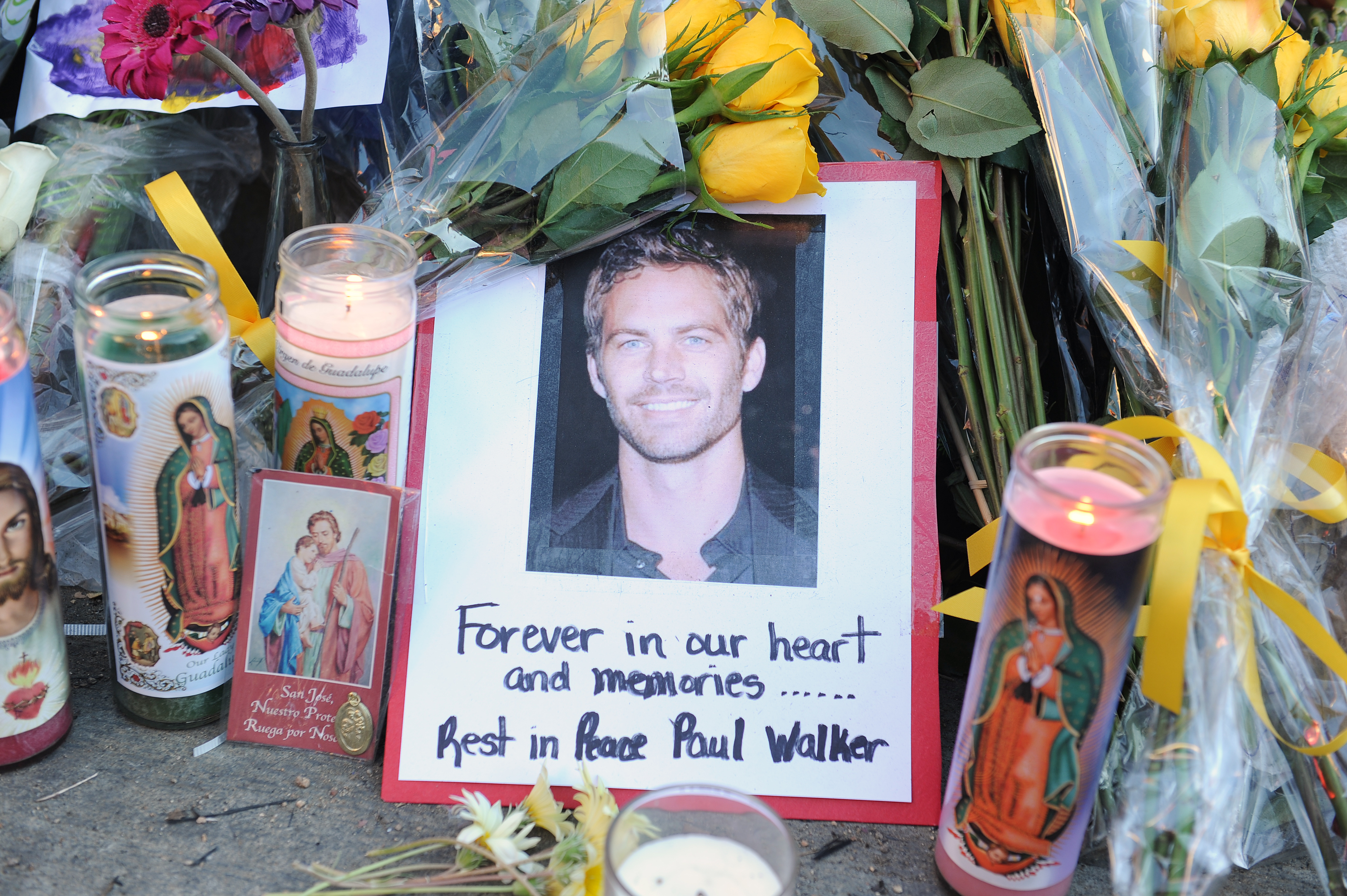 Photo of Paul walker with flowers and candles where his accident happened in California in 2013 | Source: Getty Images