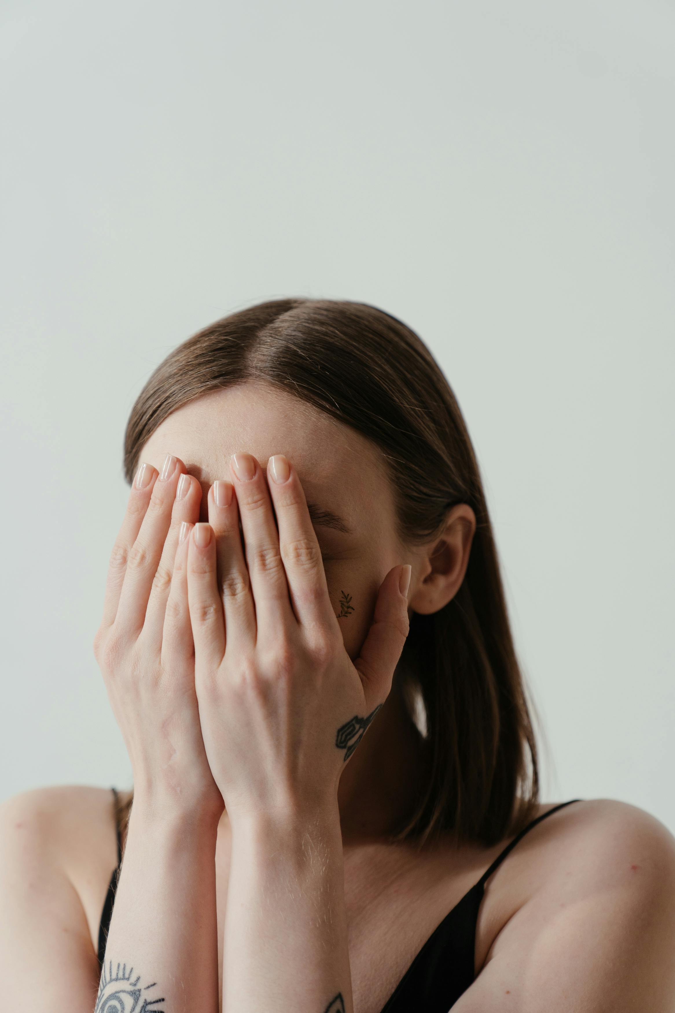 Woman covering her face with her hands | Source: Pexels