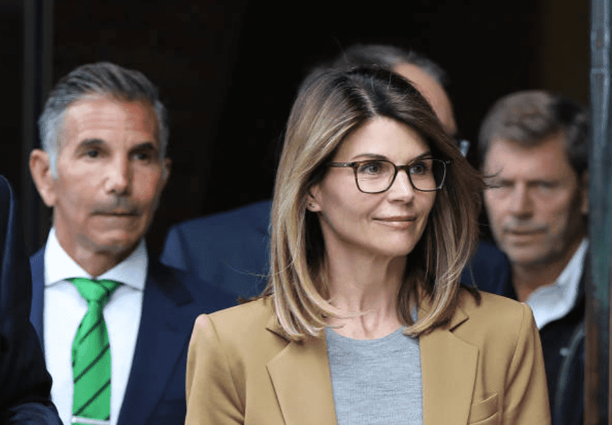 For their role in the national college admission scandal, Lori Loughlin and her husband, Mossimo Giannulli are followed by cameras as they leave the John Joseph Moakley United States Courthouse, on April 3, 2019, Boston | Source: Pat Greenhouse/The Boston Globe via Getty Images