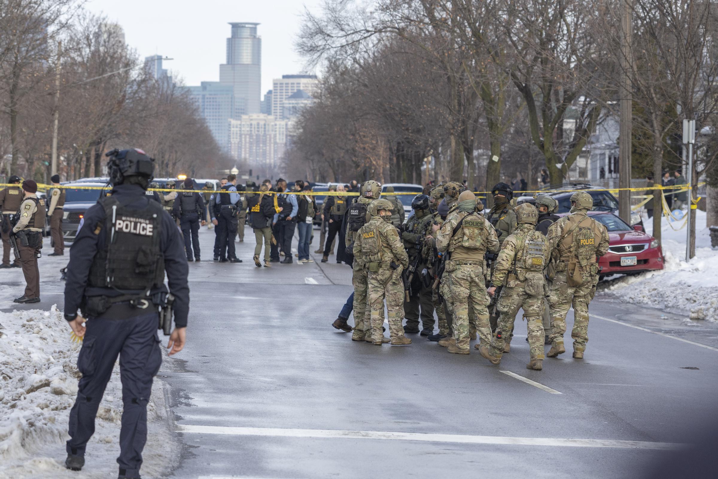 Dozens of federal and local officers secure the scene following the fatal shooting by an ICE agent in Minneapolis | Source: Getty Images
