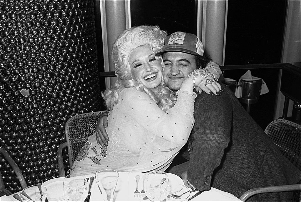 Dolly Parton and Jim Belushi. Image Credit: Getty Images Dolly Parton and Jim Belushi. Image Credit: Getty Images