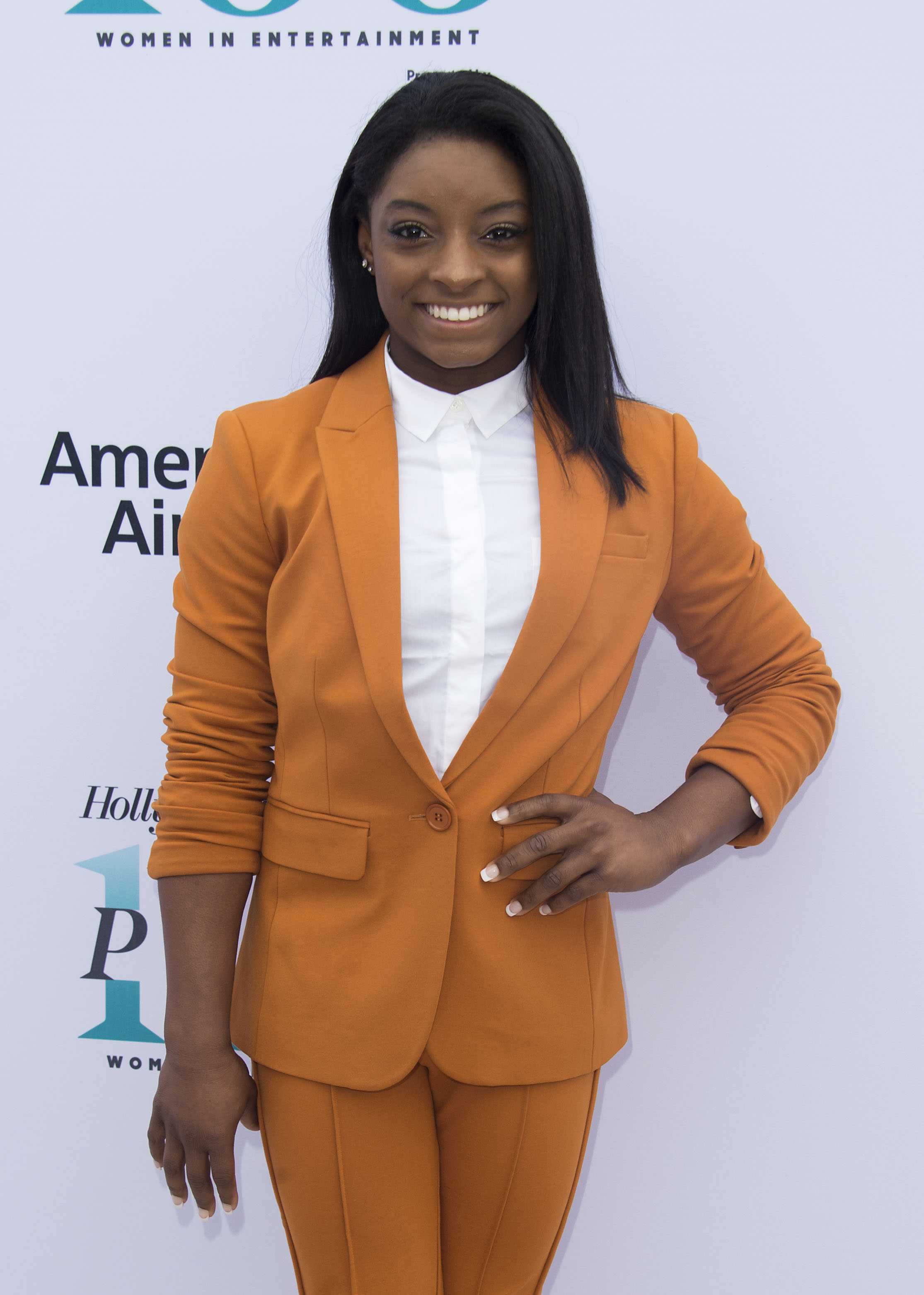 Biles steps out in a bold orange suit at The Hollywood Reporter's 25th Annual Women in Entertainment Breakfast on December 7, 2016, in Los Angeles, California. The champion gymnast traded leotards for sleek tailoring as she joined trailblazers and icons celebrating women's achievements across the industry.