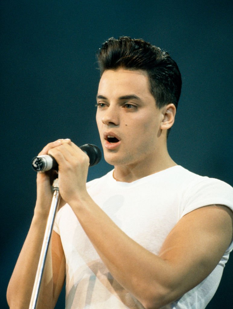 Nick Kamen pictured singing on stage in 1987, London, England. 