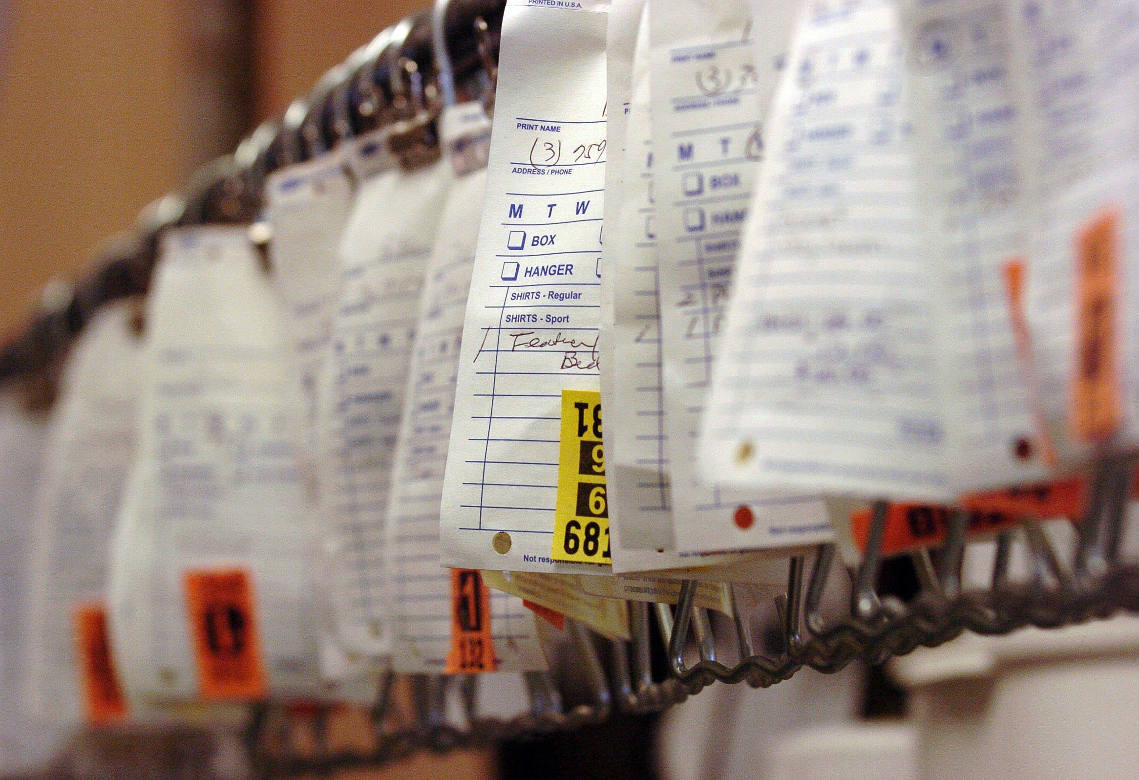 A row of tagged garments at the Magic Laundry and Dry Cleaners in South Denver | Source: Getty Images