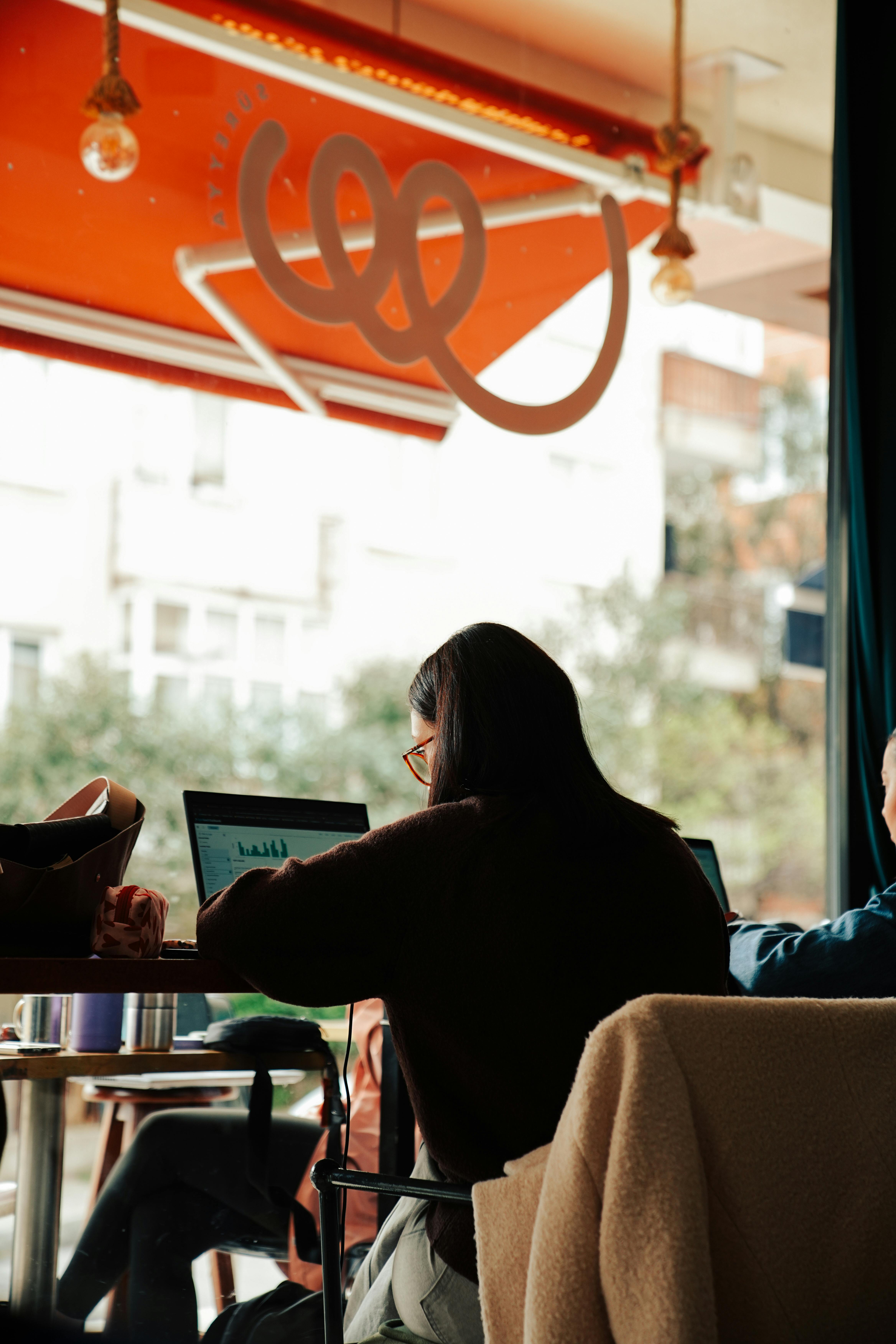 A woman window watching while working at a cafe |  Source: Pexels