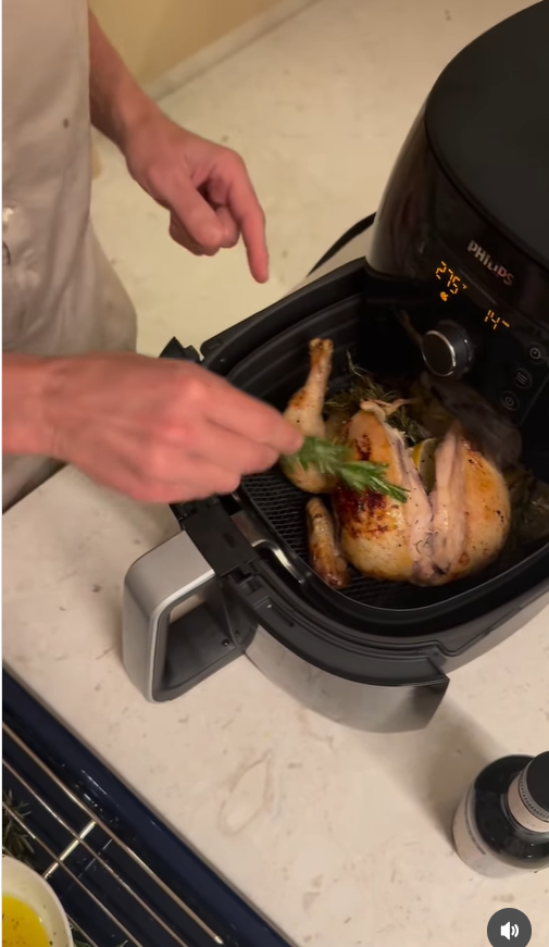 Ryan Seacrest is seen cooking a whole chicken in an air fryer, from a post dated October 1, 2025 | Source: Instagram/ryanseacrest