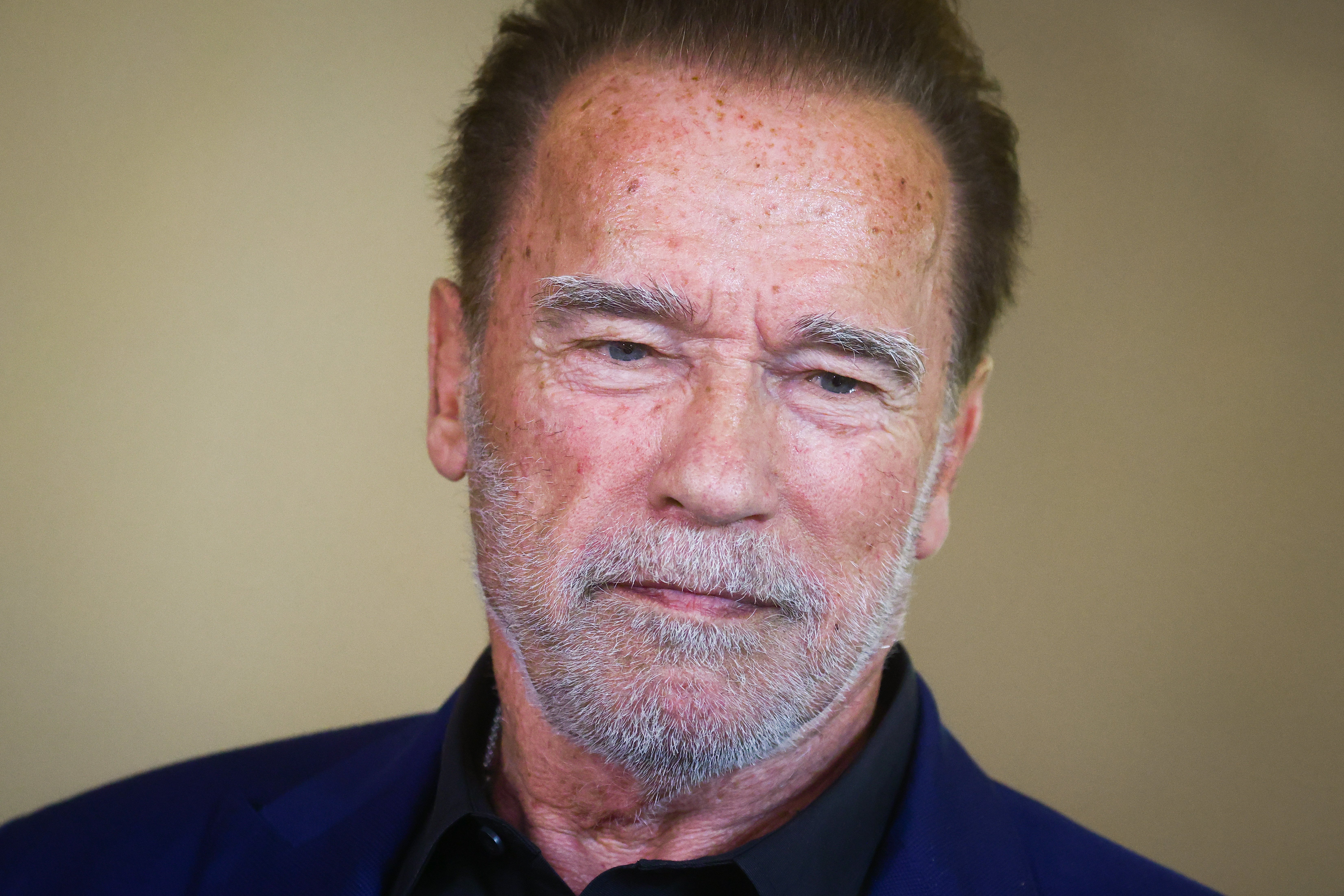 Arnold Schwarzenegger is pictured at the Auschwitz Jewish Center Foundation after visiting former Nazi German Auschwitz Birkenau concentration and extermination camp. | Source: Getty Images