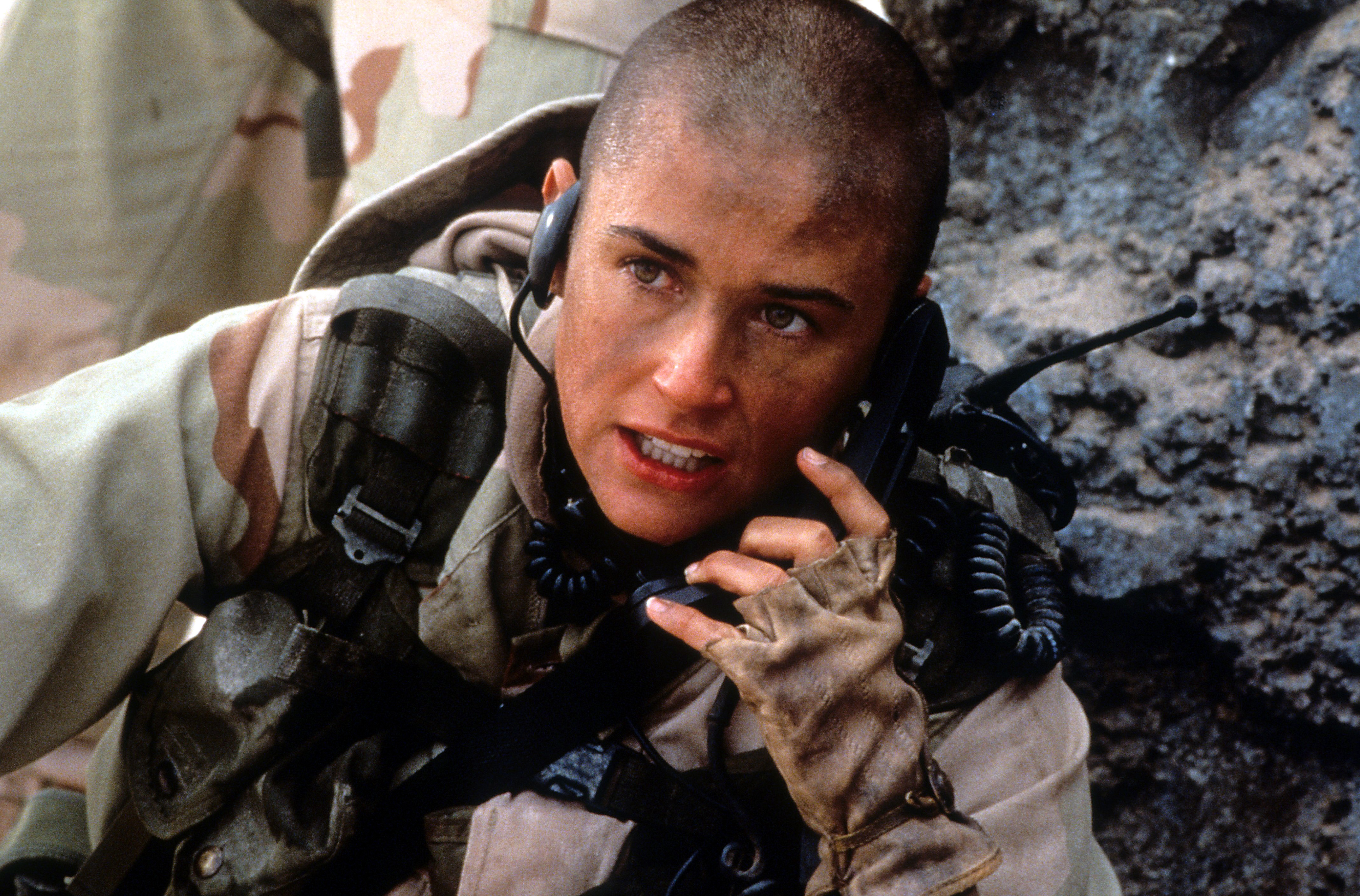 Demi Moore talking on a walkie-talkie in a scene from the film "G.I. Jane," in 1997 | Source: Getty Images