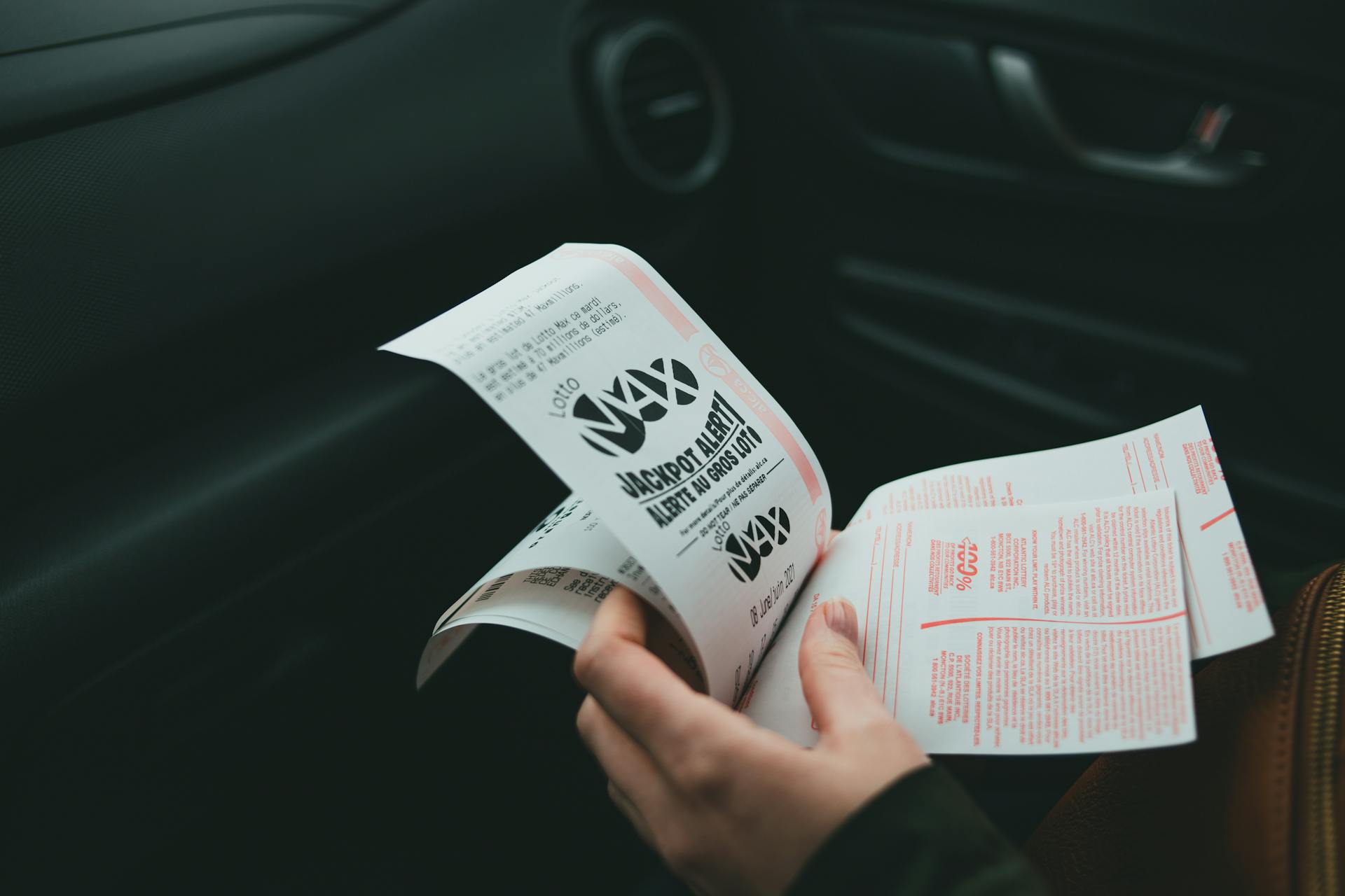A woman holding lottery tickets | Source: Pexels
