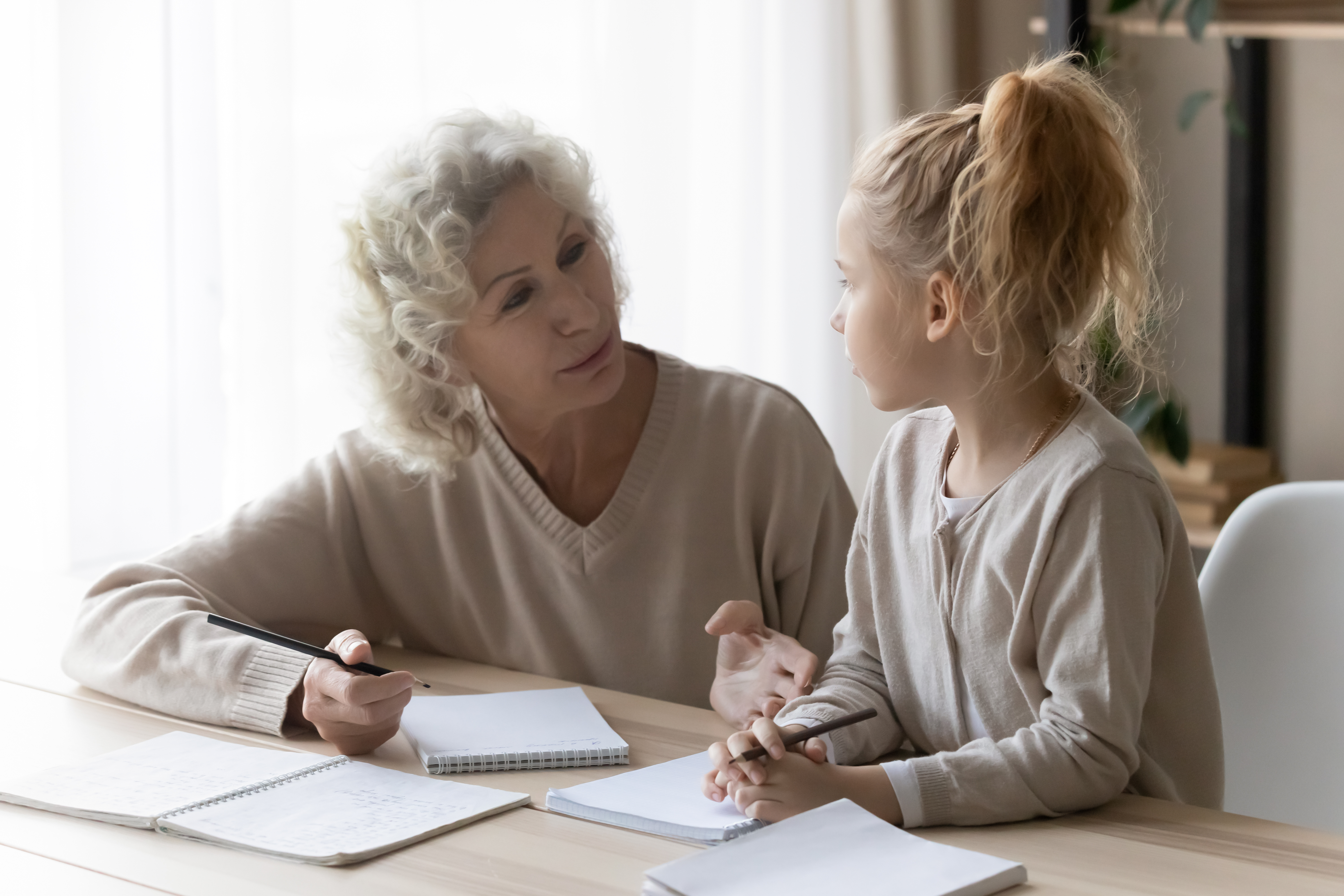 Older woman talking to a young girl | Source: Shutterstock