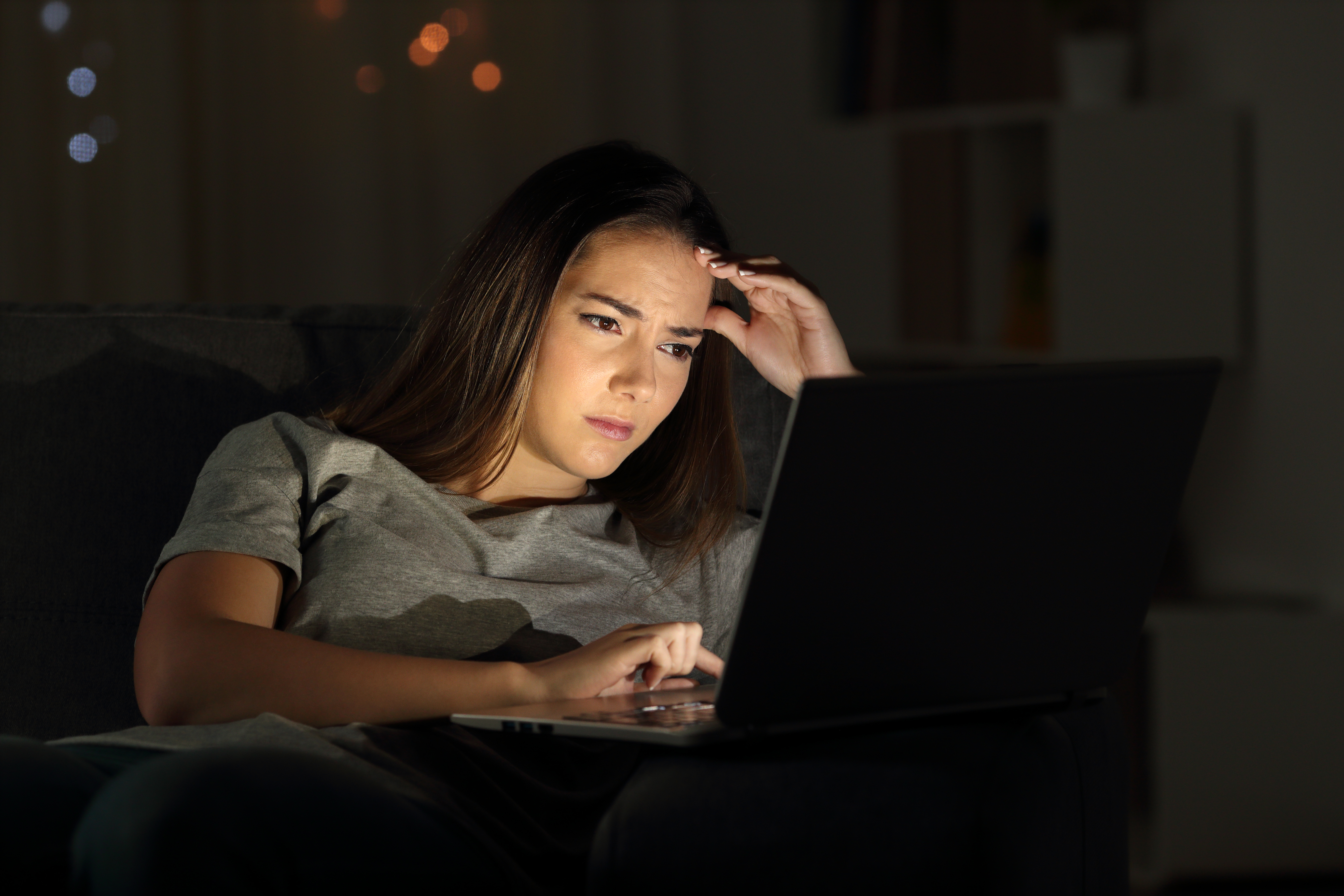 A worried woman using her laptop | Source: Shutterstock