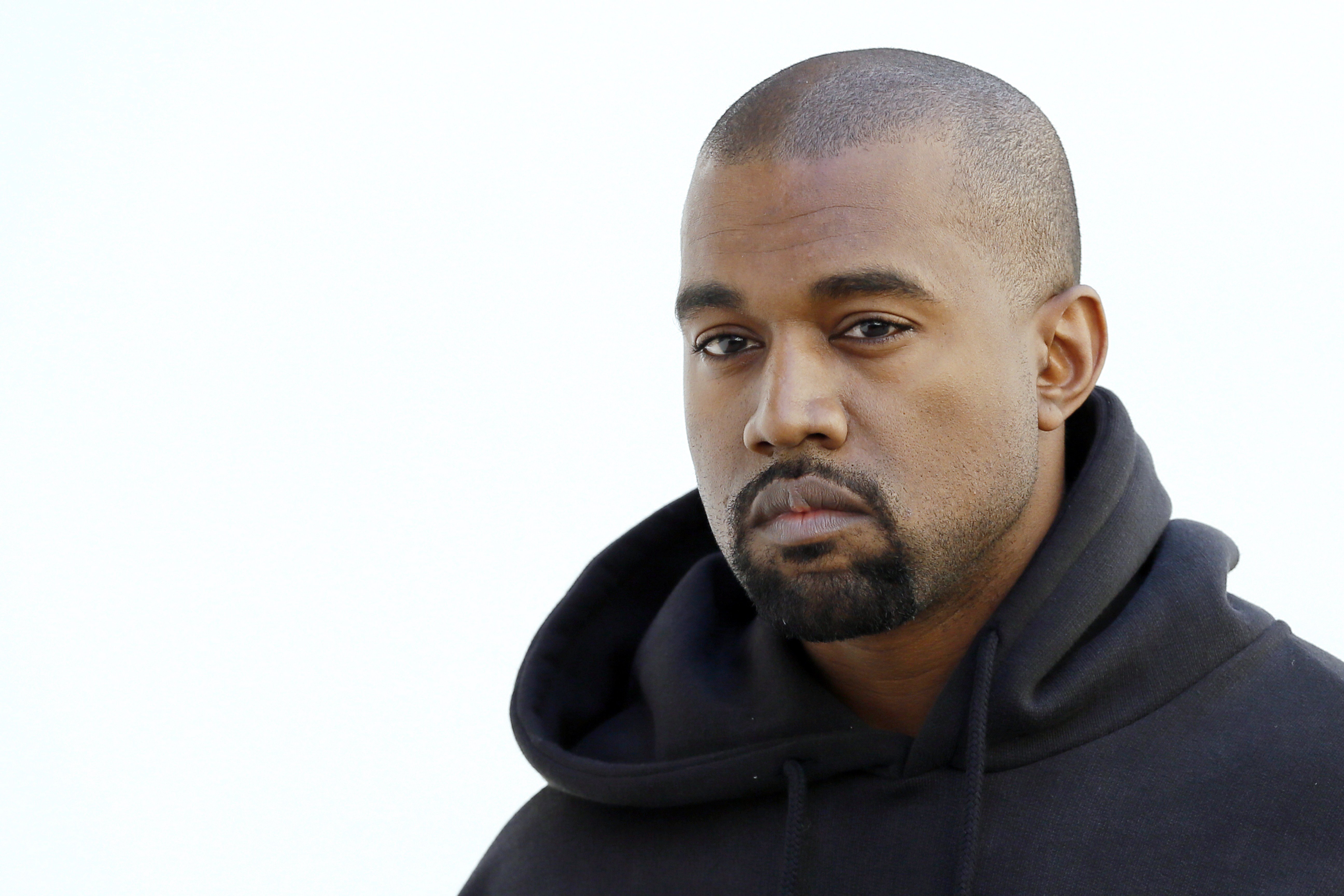 Kanye West poses before Christian Dior 2015-2016 fall/winter ready-to-wear collection fashion show on March 6, 2015, in Paris | Source: Getty Images