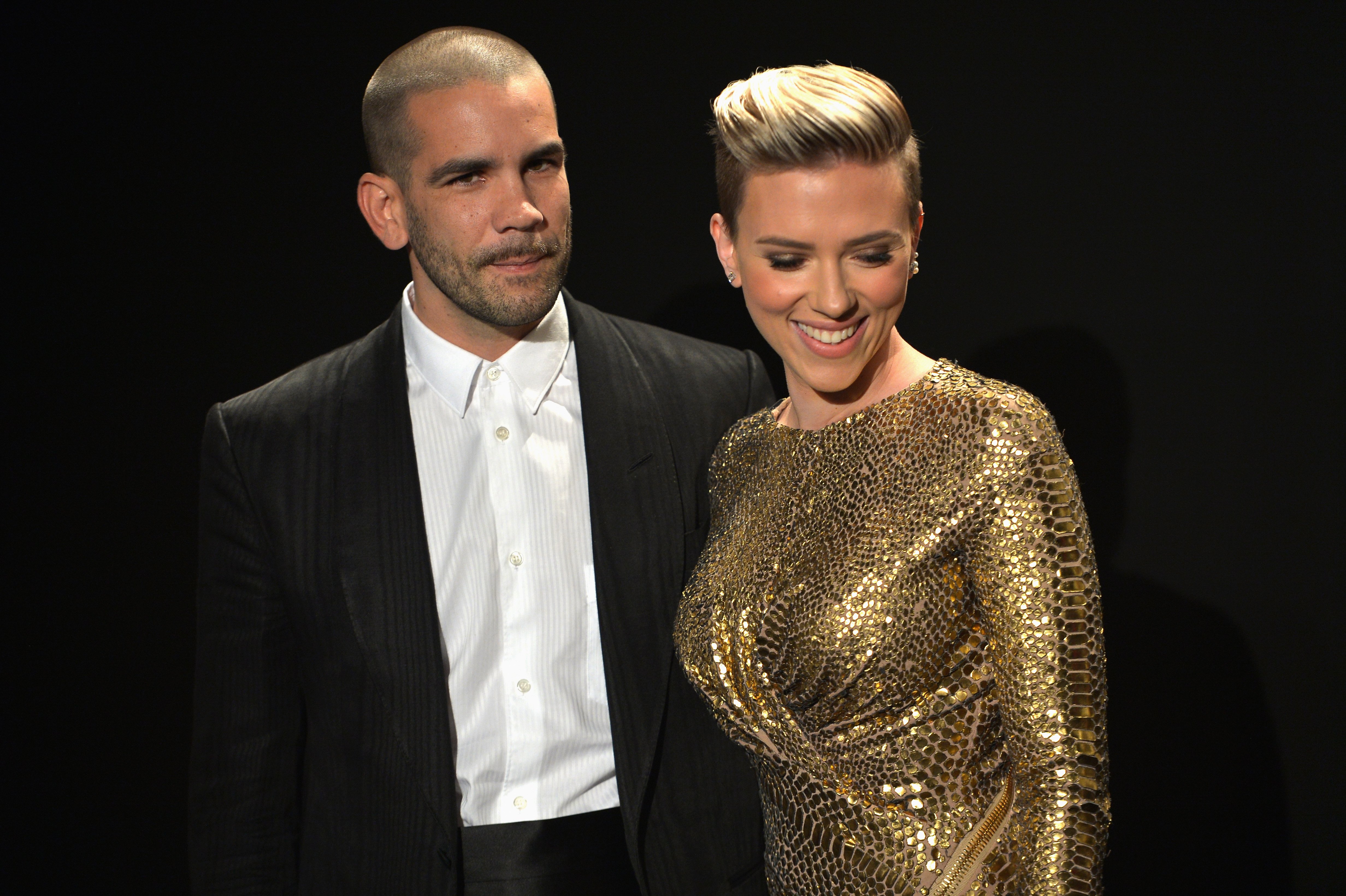 Journalist Romain Dauriac (L) and actress Scarlett Johansson, both wearing TOM FORD, attend the TOM FORD Autumn/Winter 2015 Womenswear Collection Presentation at Milk Studios in Los Angeles on February 20, 2015. Source | Getty Images 