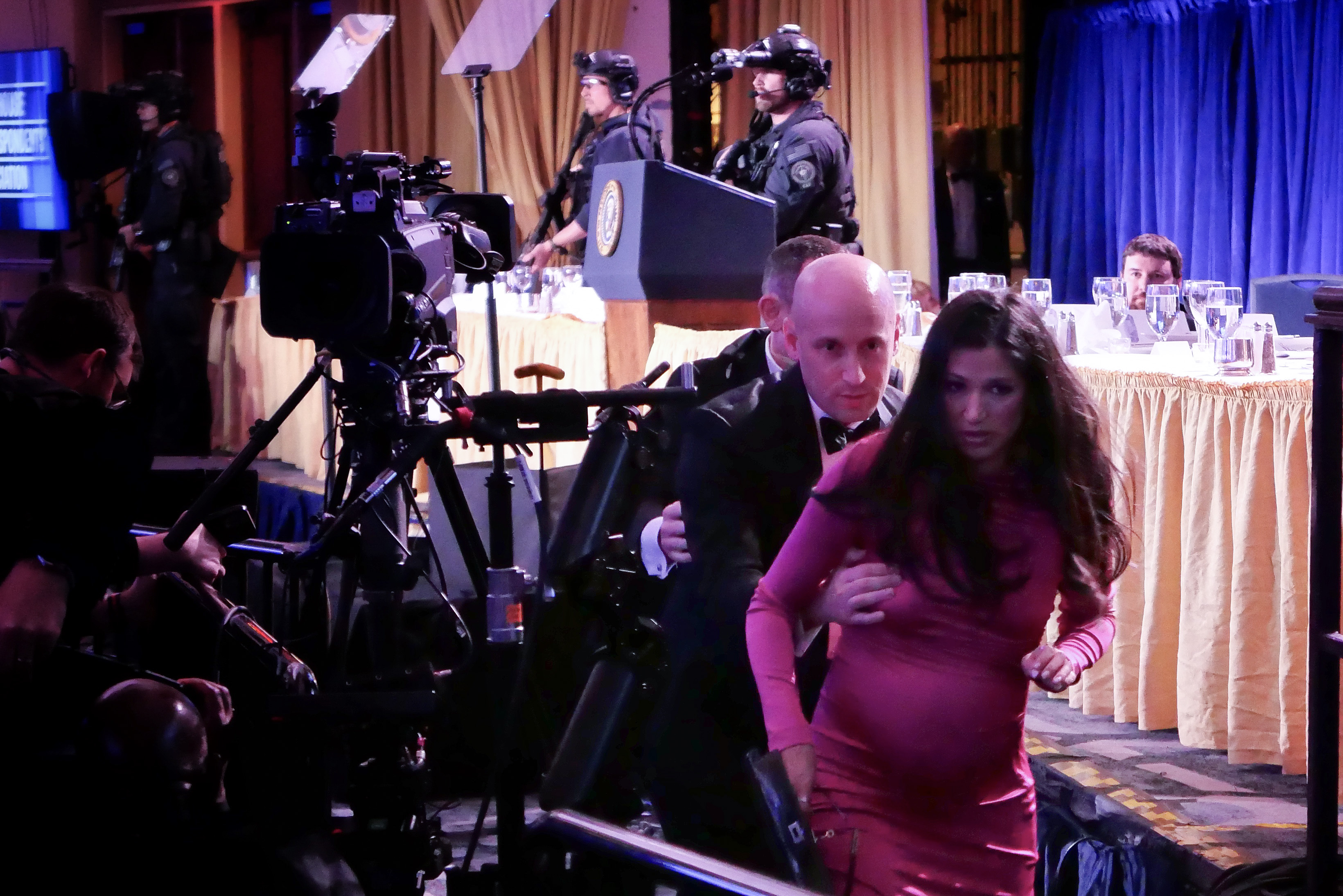 White House Deputy Chief of Staff for Policy Stephen Miller helps his wife Katie Miller during the White House gunfire incident on April 25, 2026 | Source: Getty Images