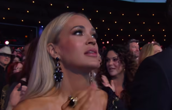 Carrie Underwood dancing, clapping, and singing along to Alan Jackson's performance. | Source: Facebook/Grand Ole Opry