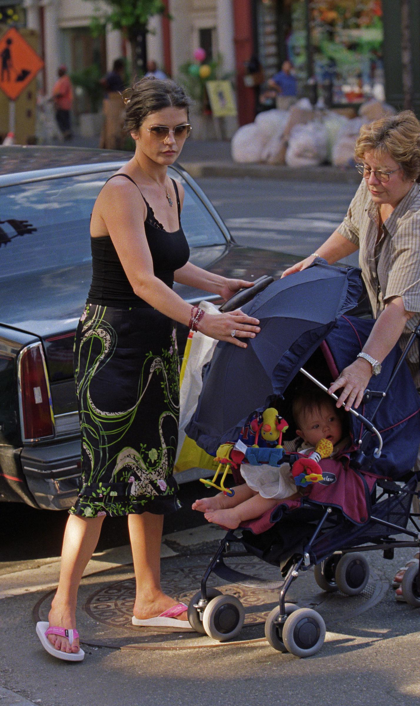 Catherine Zeta-Jones, wife of Michael Douglas, out for a stroll with son, Dylan (in stroller) and nanny on Columbus Avenue near their home in New York City on June 25, 2001 | Source: Getty Images