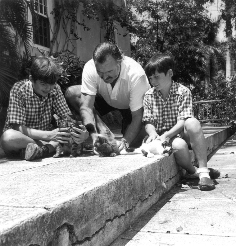 Ernest Hemingway with sons Patrick (left) and Gregory (right) in Finca Vigia, Cuba in 1942 |  Source: Wikimedia Commons/ Owned by John F. Kennedy Presidential Library and Museum, Ernest Hemingway with sons Patrick and Gregory with kittens in Finca Vigia, Cuba, marked as public domain