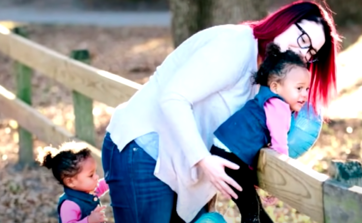 A woman and the twin girls she adopted after seeing them in the hospital where she works as a nurse | Photo: Youtube/Inside Edition