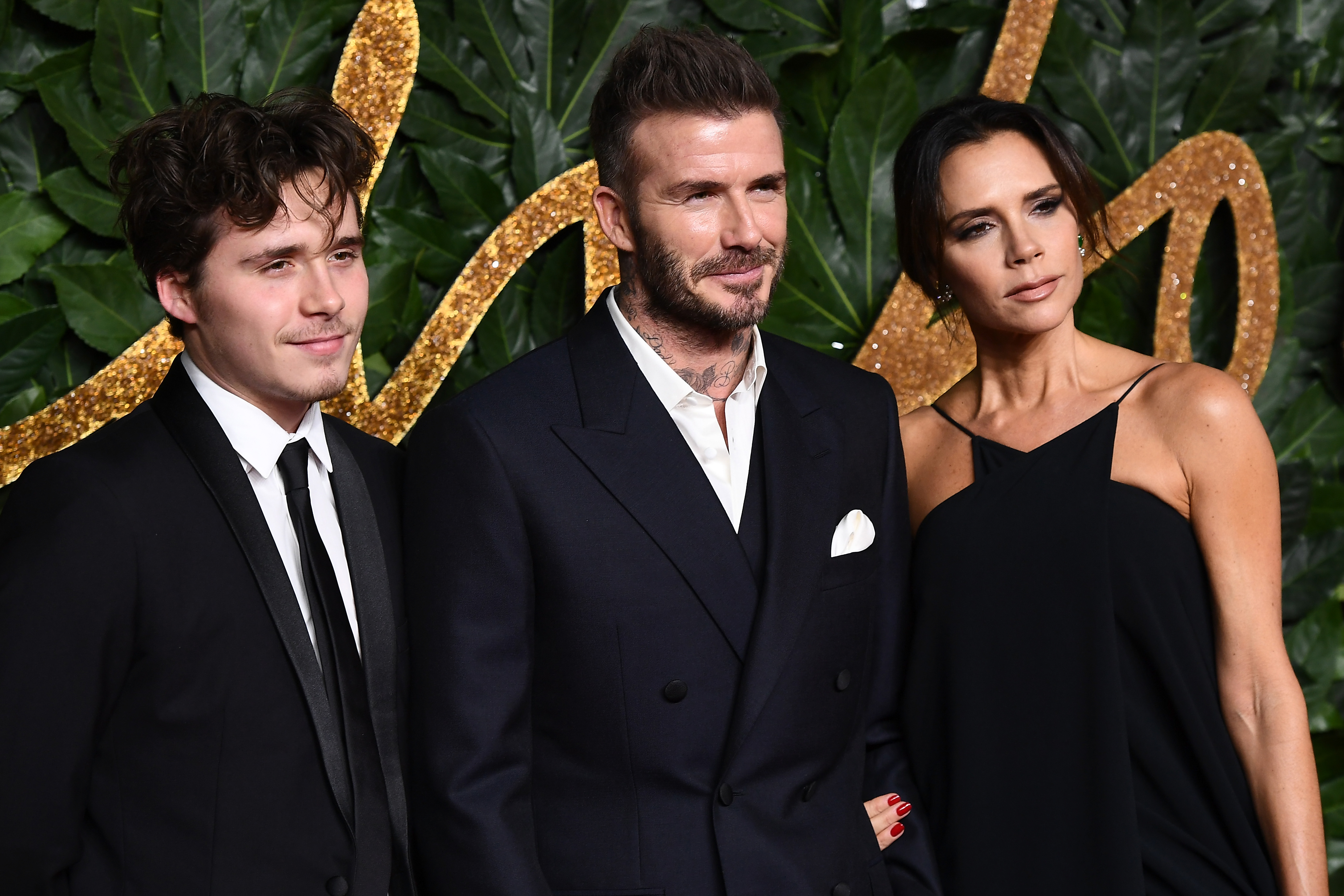 Brooklyn Peltz Beckham with Sir David and Victoria Beckham at The Fashion Awards 2018 on December 10 in London, England. | Source: Getty Images