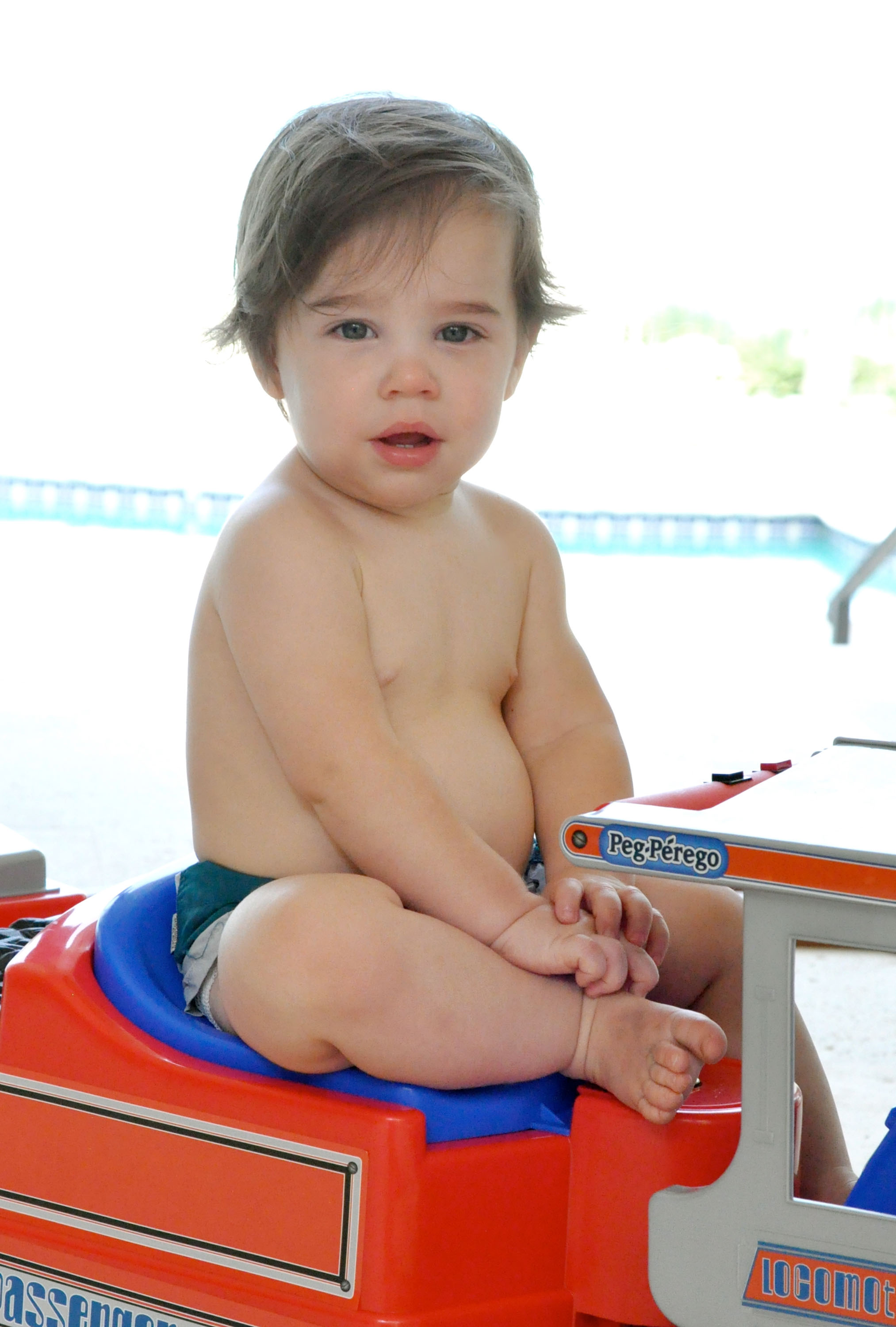 Valentino Martin sits barefoot on a red-and-blue toy vehicle wearing only a diaper in a handout photo provided by Ricky Martin in Miami, Florida.