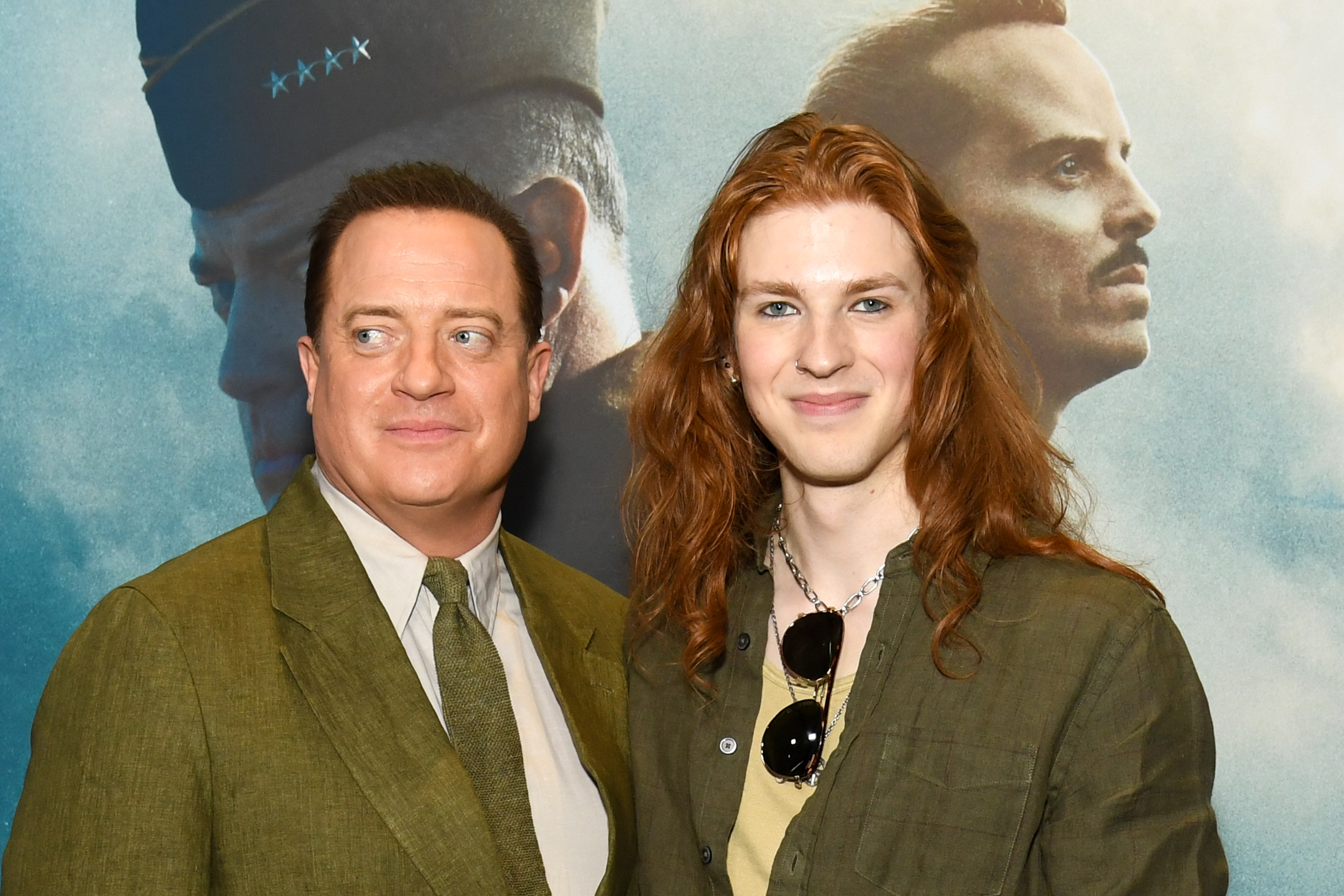 Brendan Fraser poses beside Leland Francis Fraser at the New York premiere of "Pressure" on May 26, 2026, with both standing before the film's dramatic promotional backdrop.