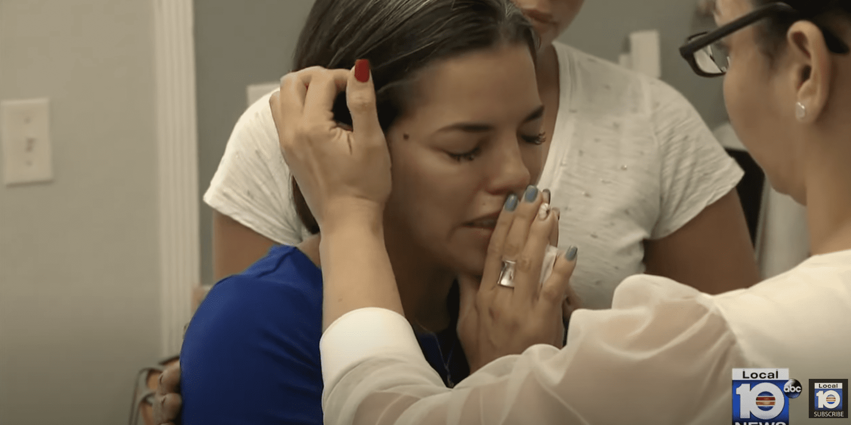 A teary-eyed Yanet Leal Concepcion is comforted by her loved ones. | Source: YouTube.com/WPLG Local 10
