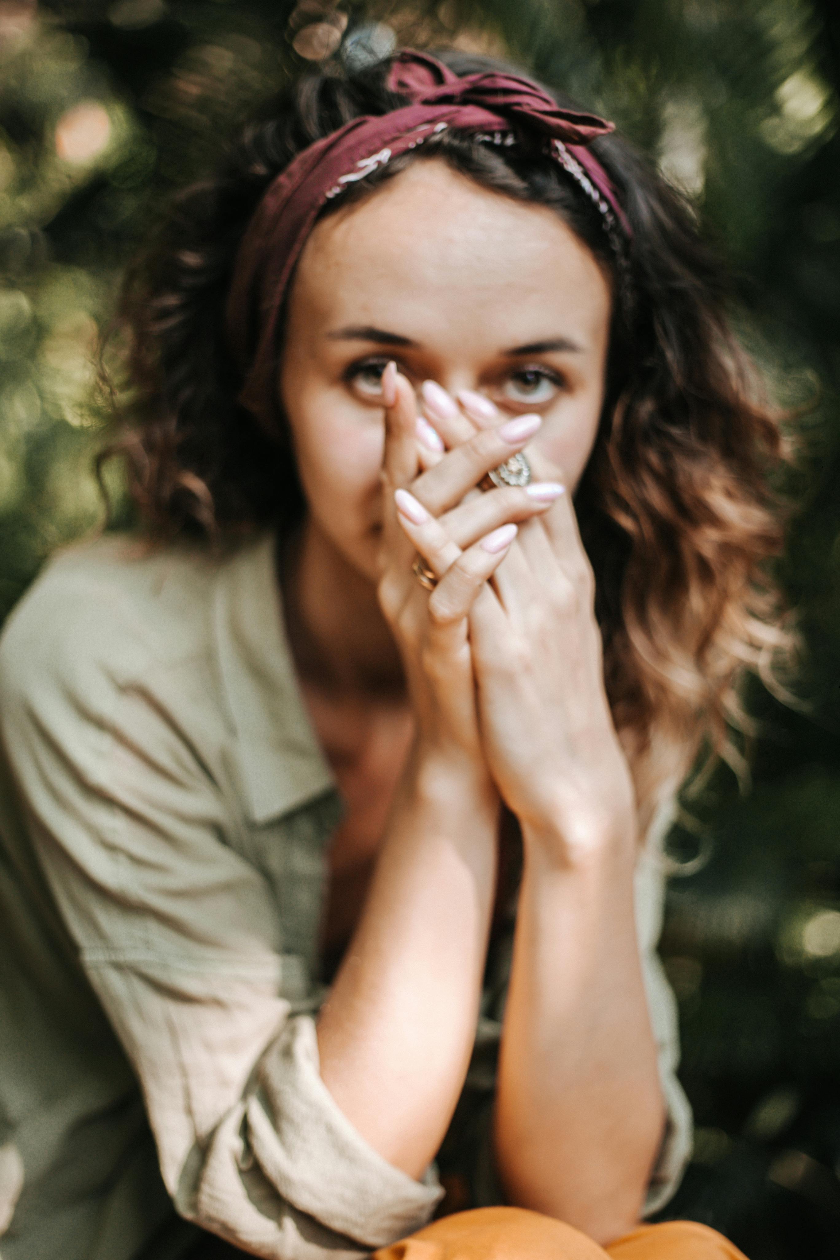 A woman covering her mouth and face in embarrassment | Source: Pexels