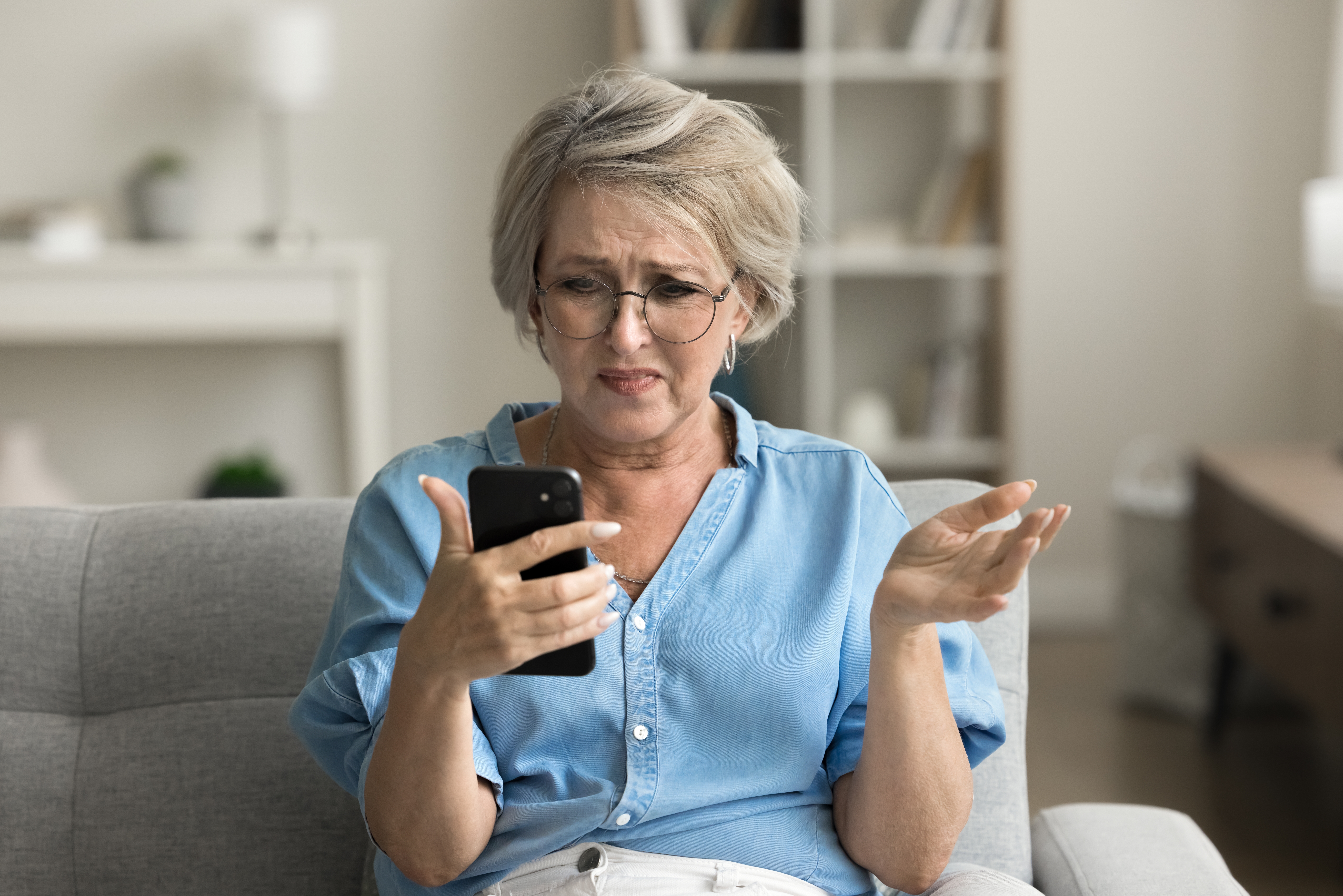 Frustrated senior woman seeing something upsetting on her phone | Source: Shutterstock