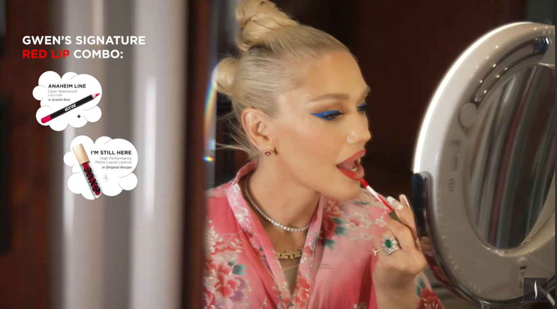 A screenshot showing Gwen Stefani applying her signature red lipstick in a Sephora tutorial video on April 23, 2024. | Source: YouTube/Sephora
