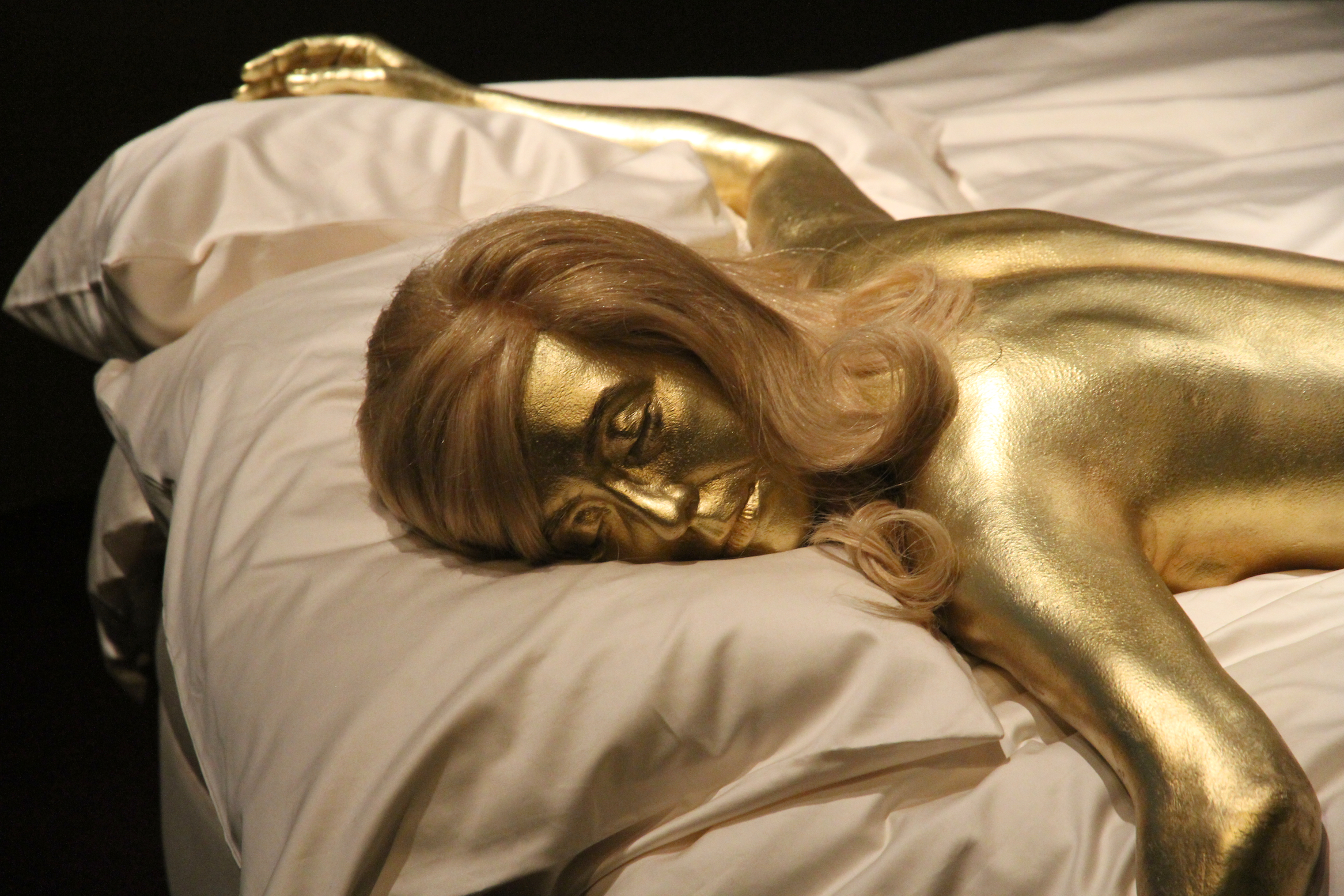 A Reproduction of the gold-painted Shirley Eaton as Jill Masterson in the film "Goldfinger," on July 5, 2012. | Source: Getty Images