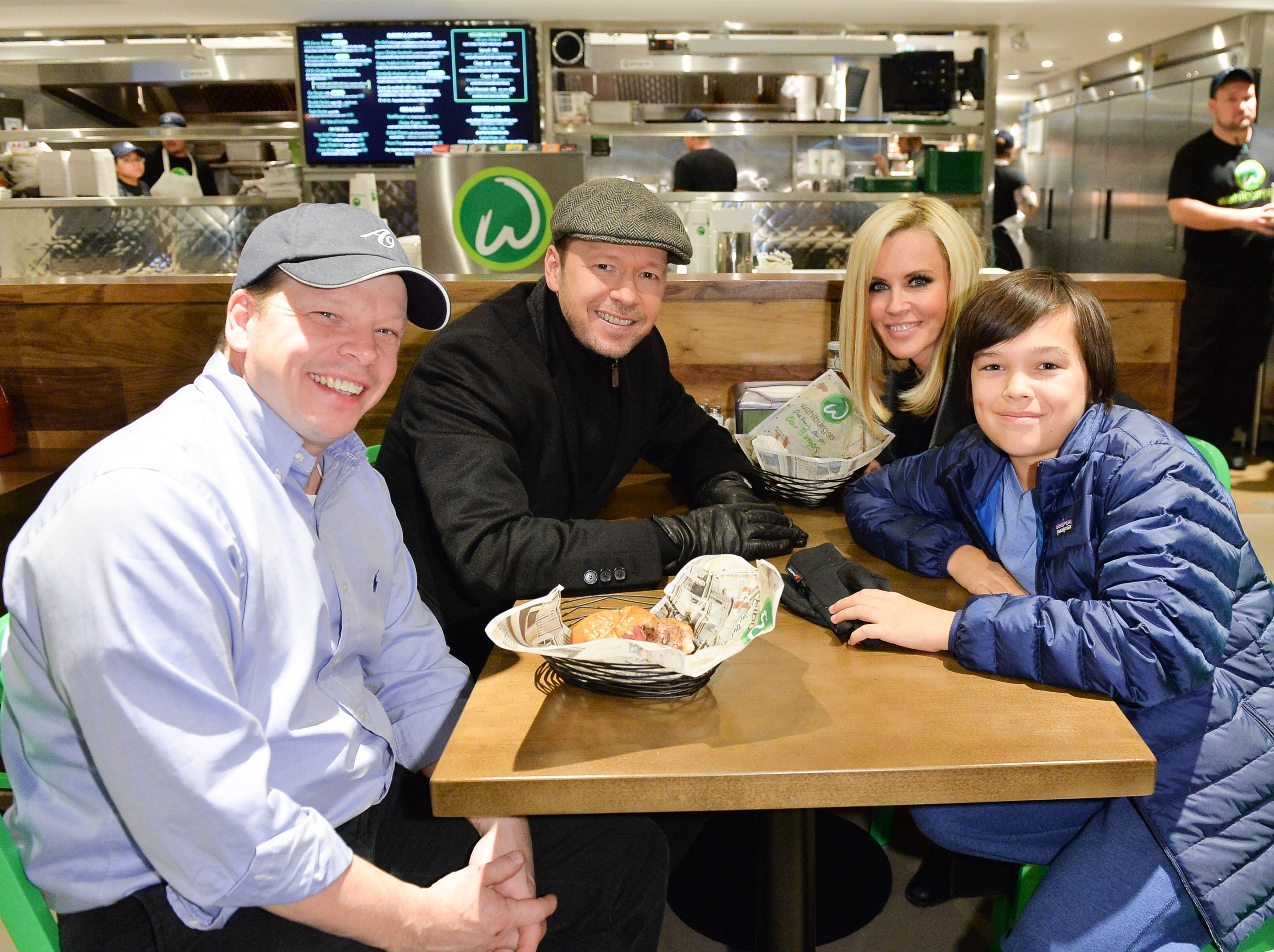 Paul Wahlberg, Donnie Wahlberg, Jenny McCarthy and Elijah Wahlberg enjoy a Wahlbuger at the launch of Wahlburgers Family Restaurant on November 15, 2014, in Toronto, Canada. | Source: Getty Images