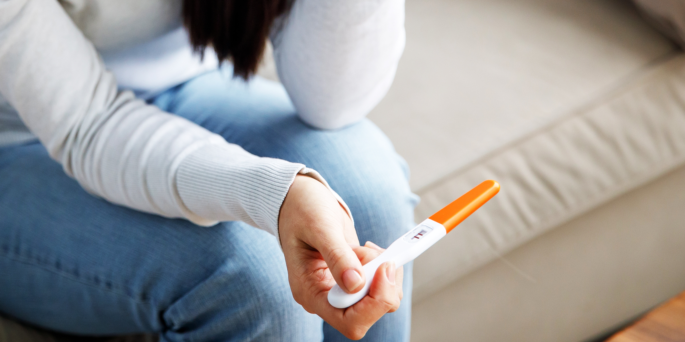 A woman holding a pregnancy test | Source: Shutterstock