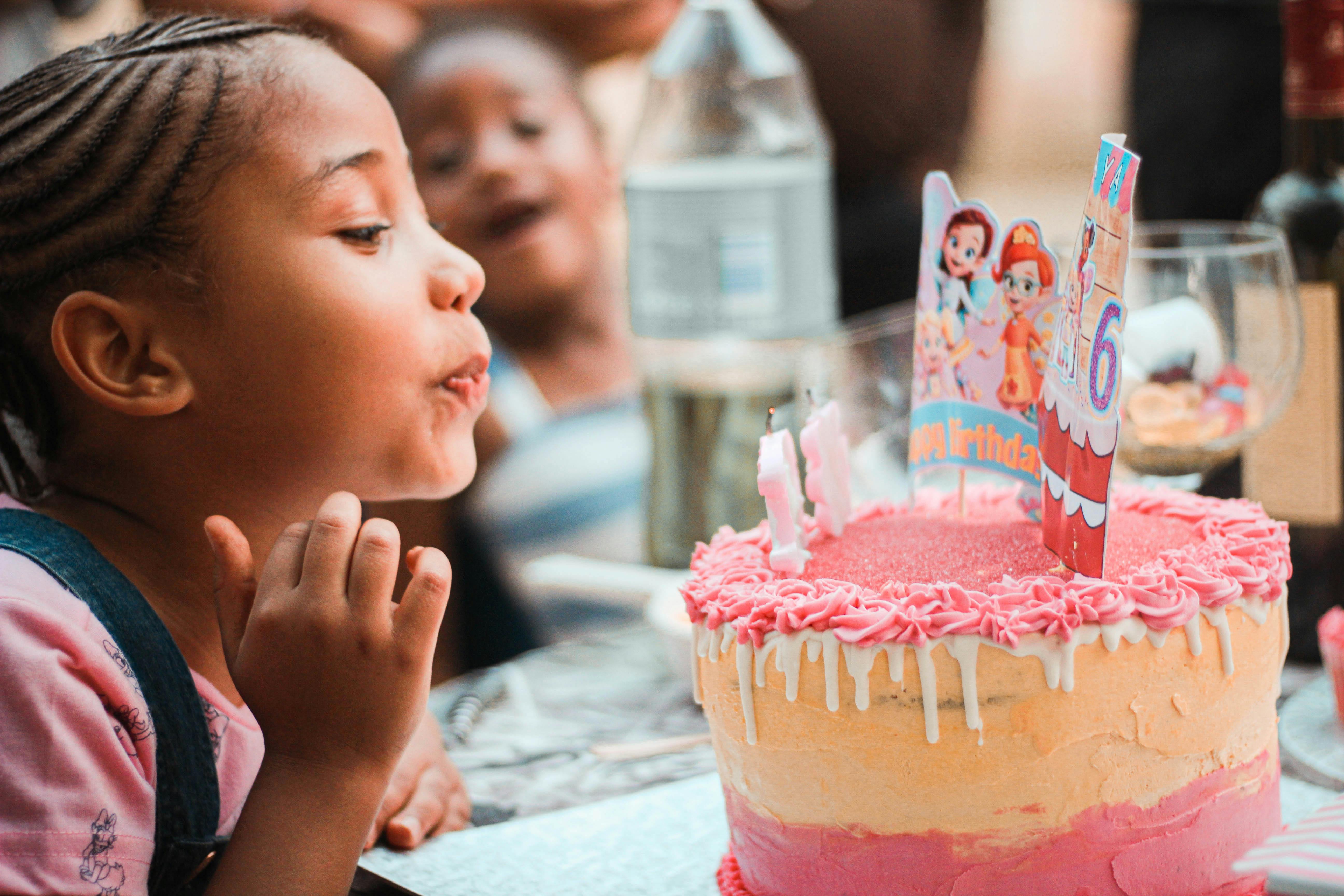 A girl blowing the candles on her cake | Source: Pexels