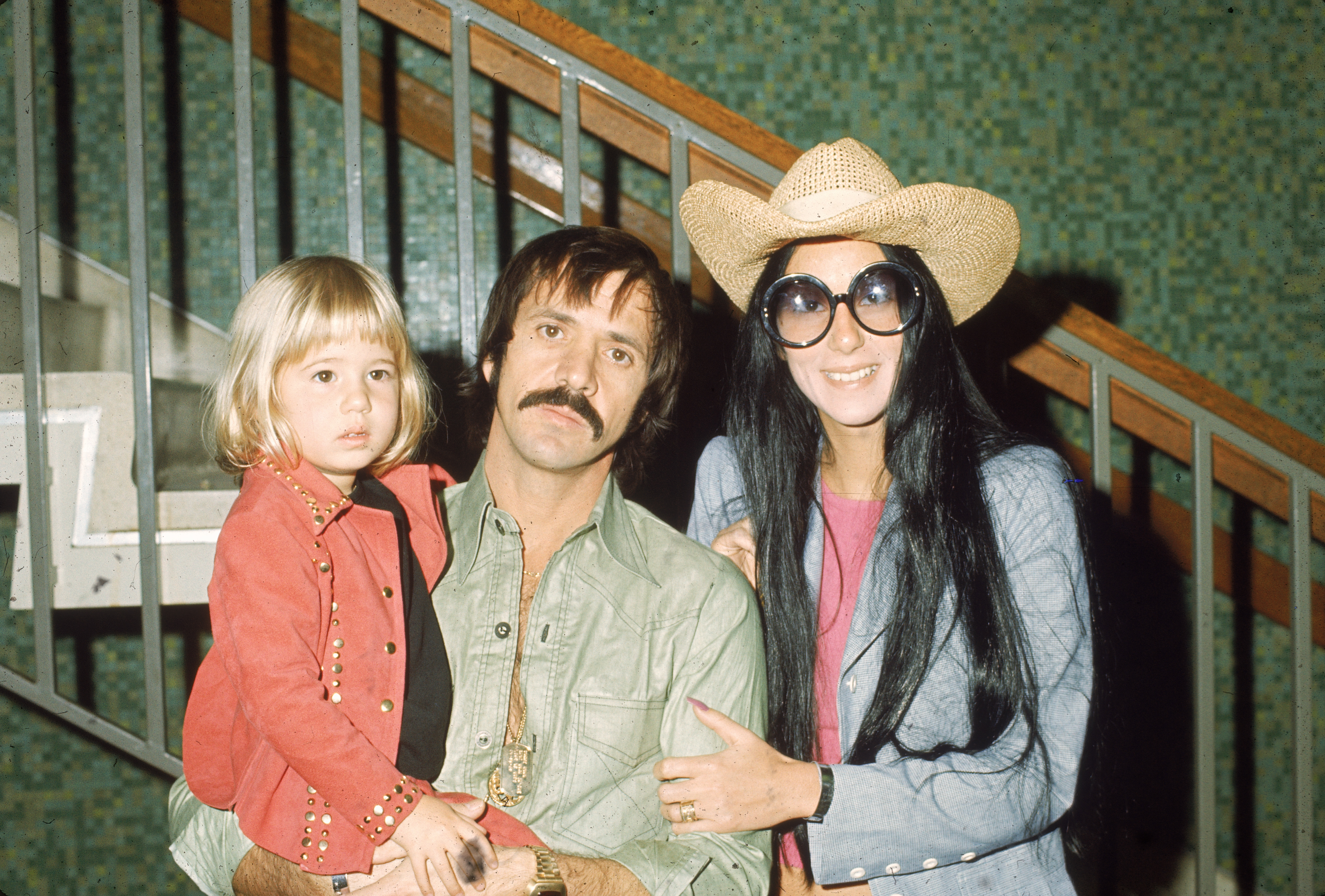 Sonny and Cher Bono pose with Chastity Bono in front of a staircase, on March 1, 1973.