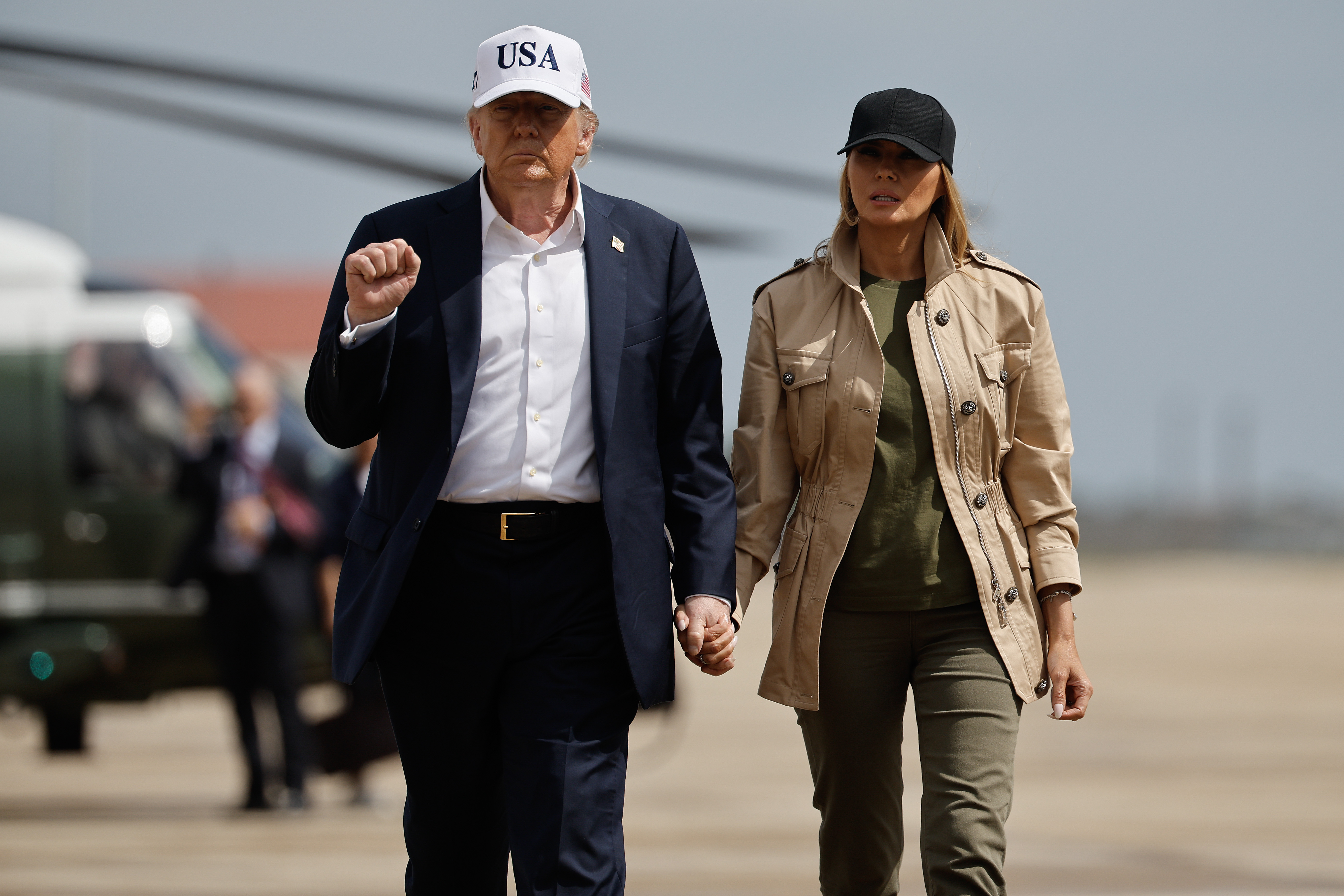 President Donald Trump and first lady Melania Trump visit walk across the tarmac at Lackland Air Force Base in San Antonio, Texas on July 11, 2025 | Source: Getty Images