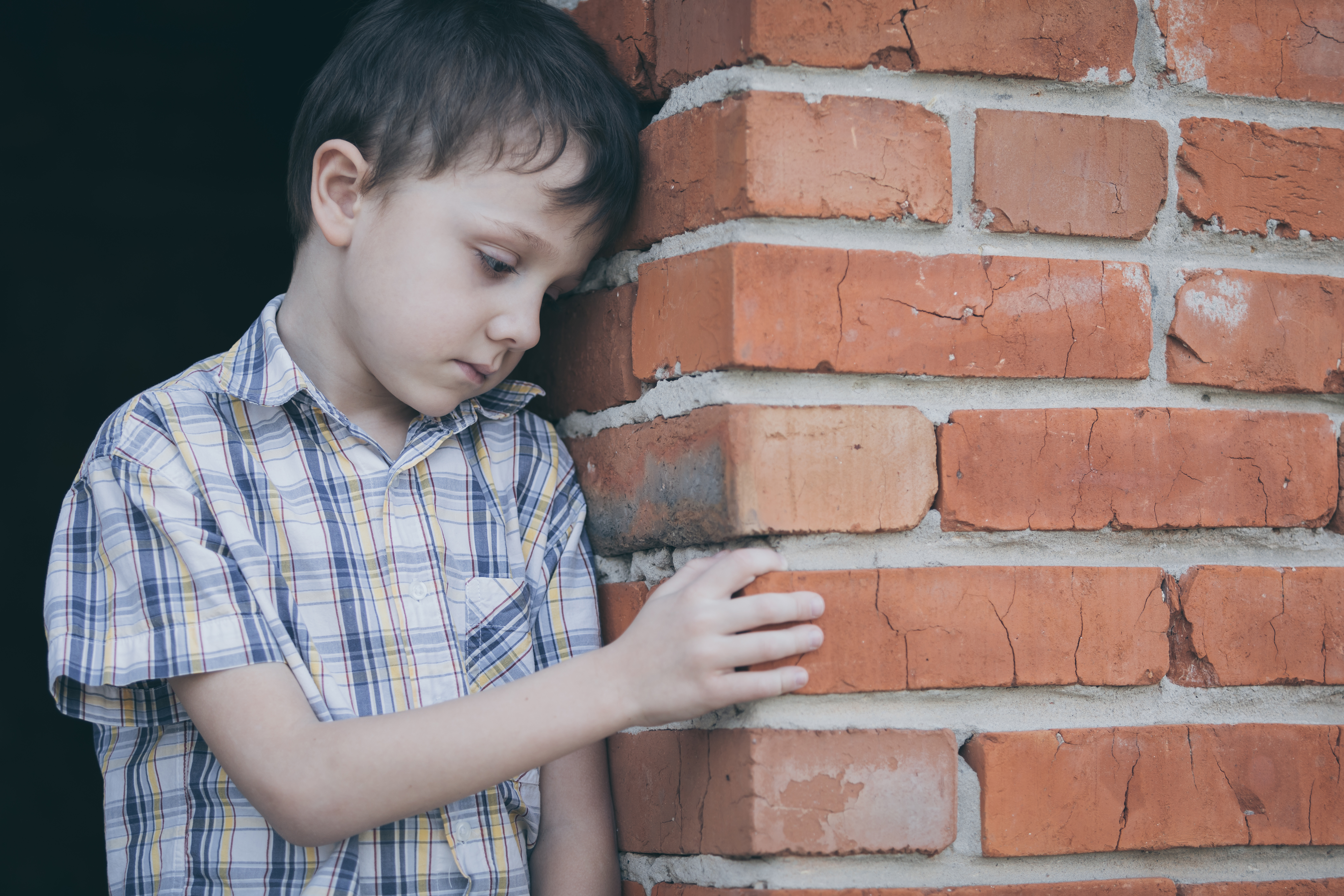 Portrait of sad little boy outdoors at the day time. | Source: Shutterstock