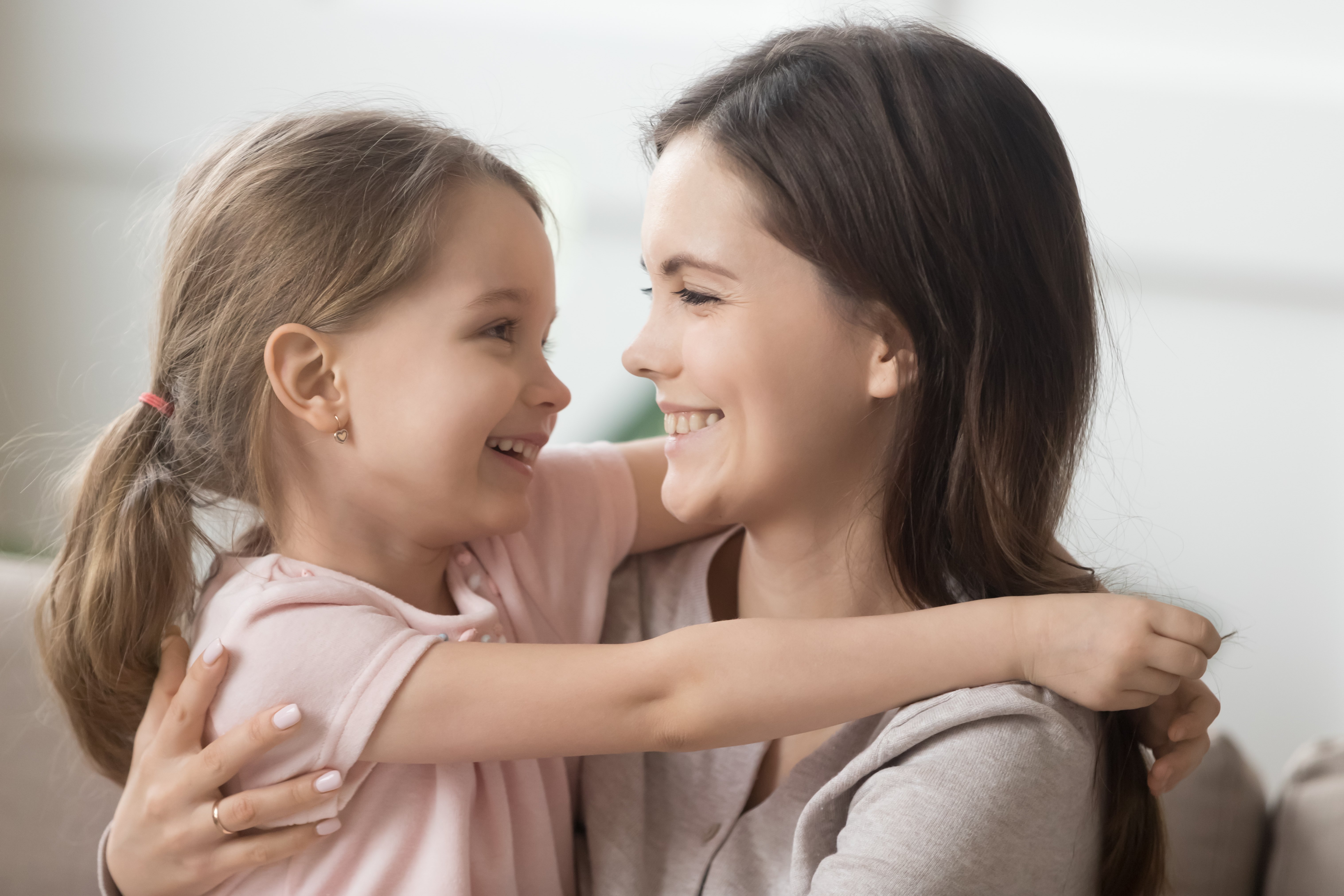 Smiling mother and daughter | Source: Shutterstock.com