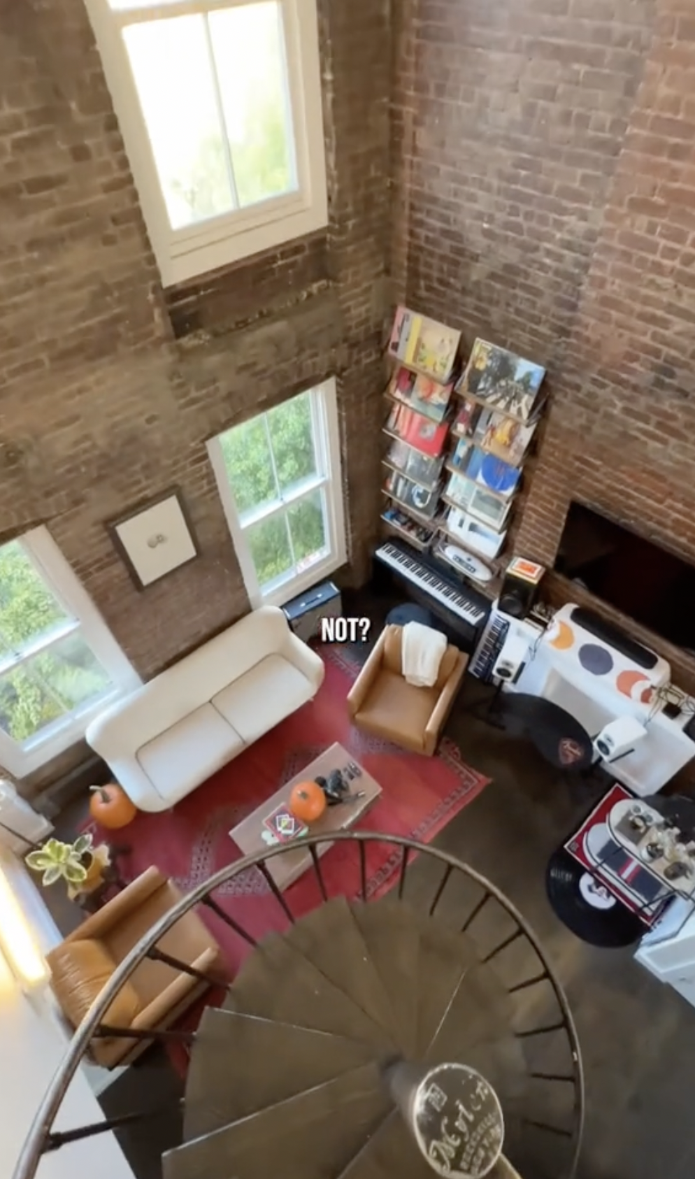 A birds-eye view of Deacon Phillippe's living room and spiral staircase inside his apartment in West Village, New York posted on November 15, 2023 | Source: TikTok/calebwsimpson