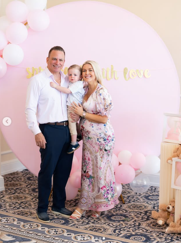 Karoline Leavitt poses with her husband, Nicholas Riccio, and their son, Niko, during her baby shower celebration | Source: Instagram/karolineleavitt