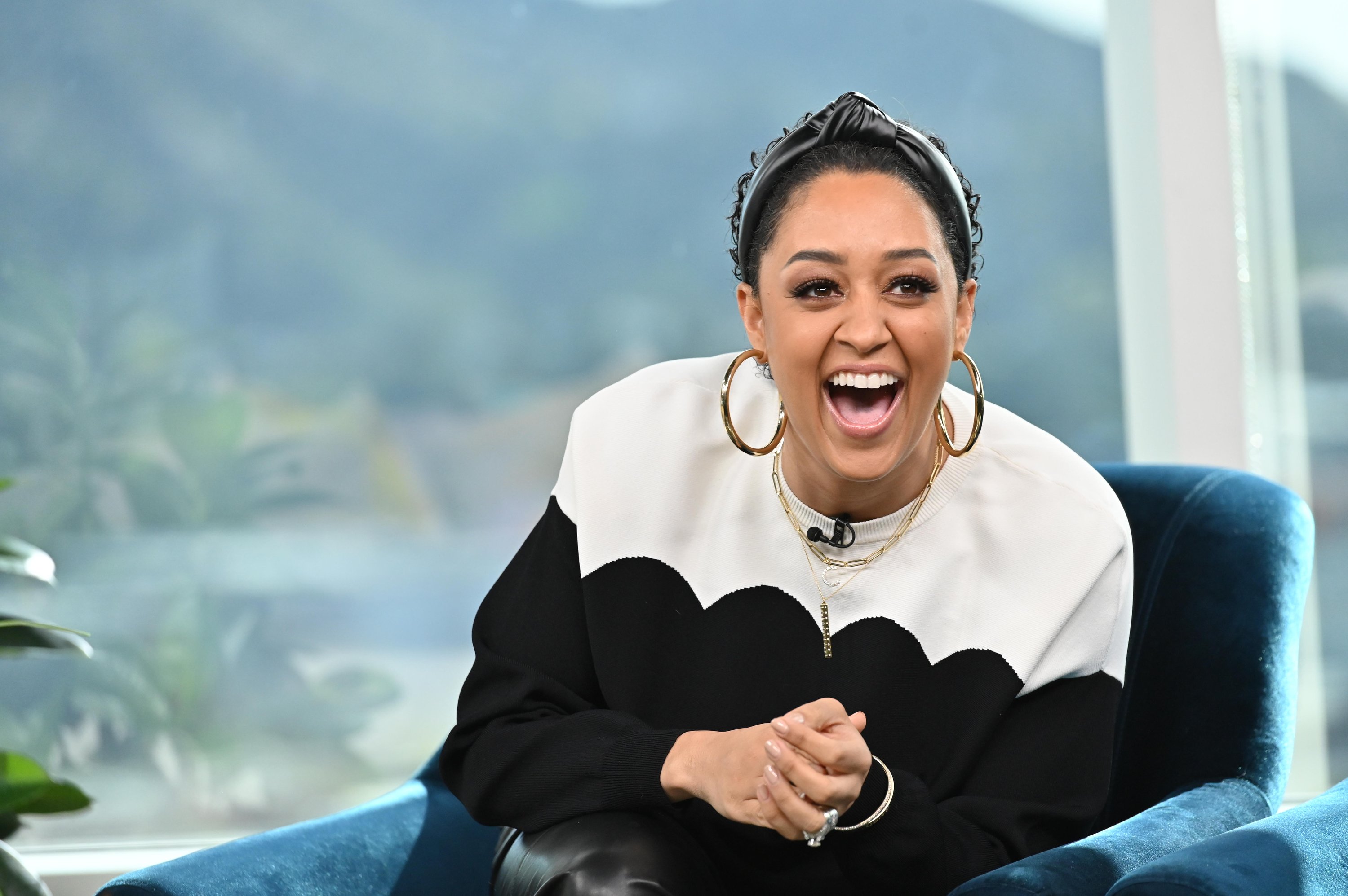 Tia Mowry-Hardrict featured during filming on the set of E!’s Daily Pop.| Source: Getty Images