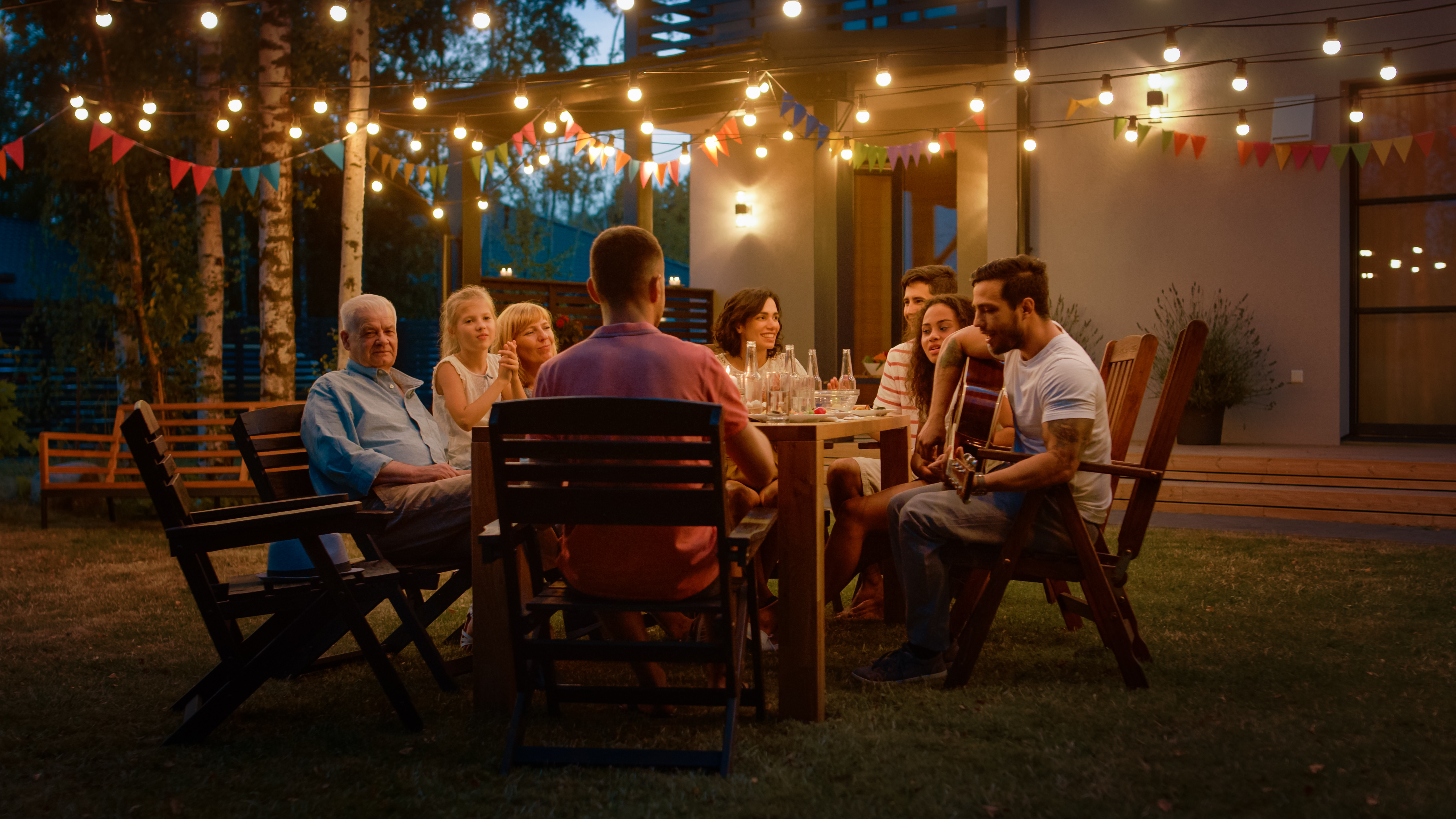 A family eating dinner outdoors | Source: Shutterstock