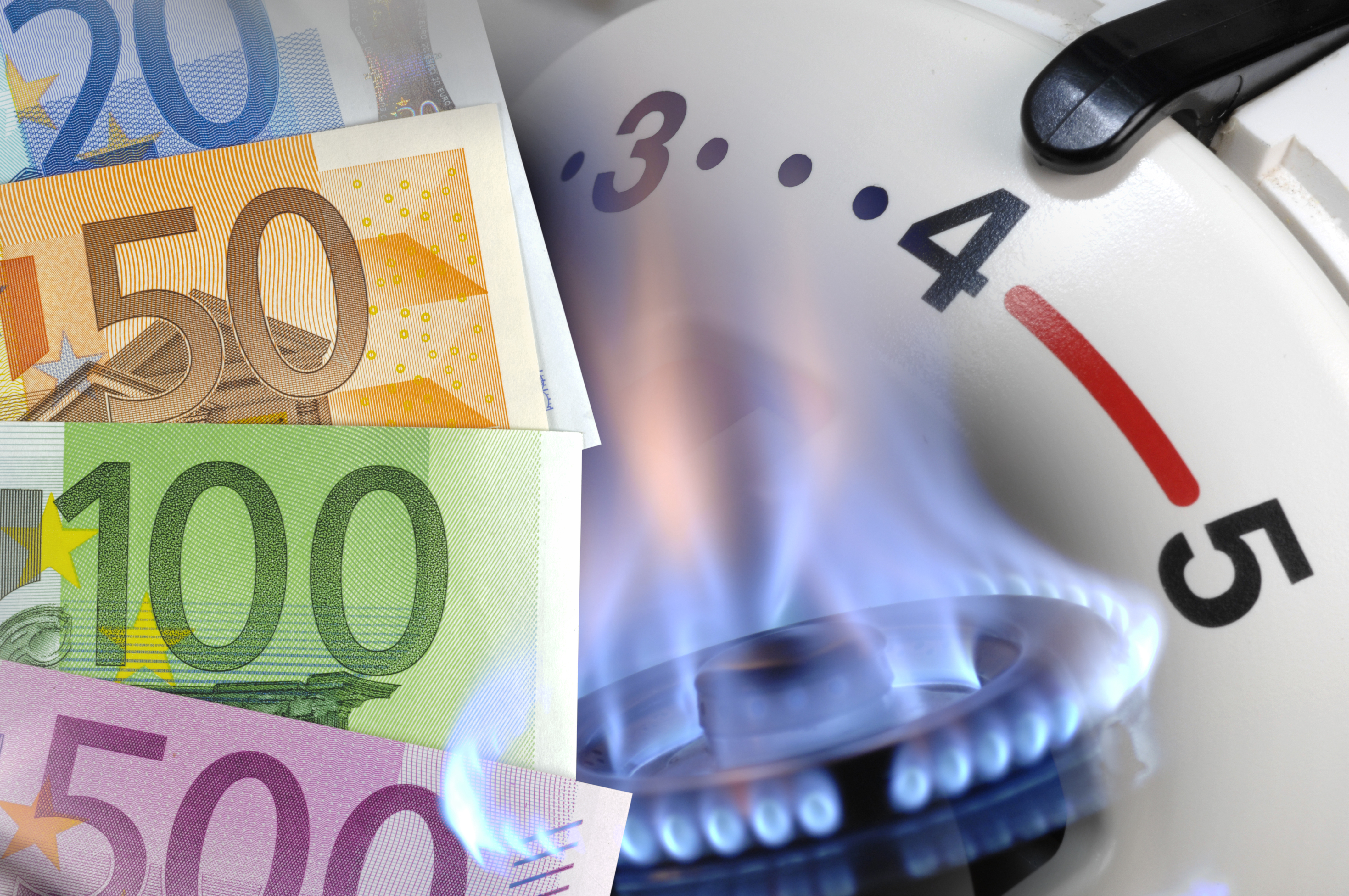 Money next to a gas meter and burner | Source: Getty Images
