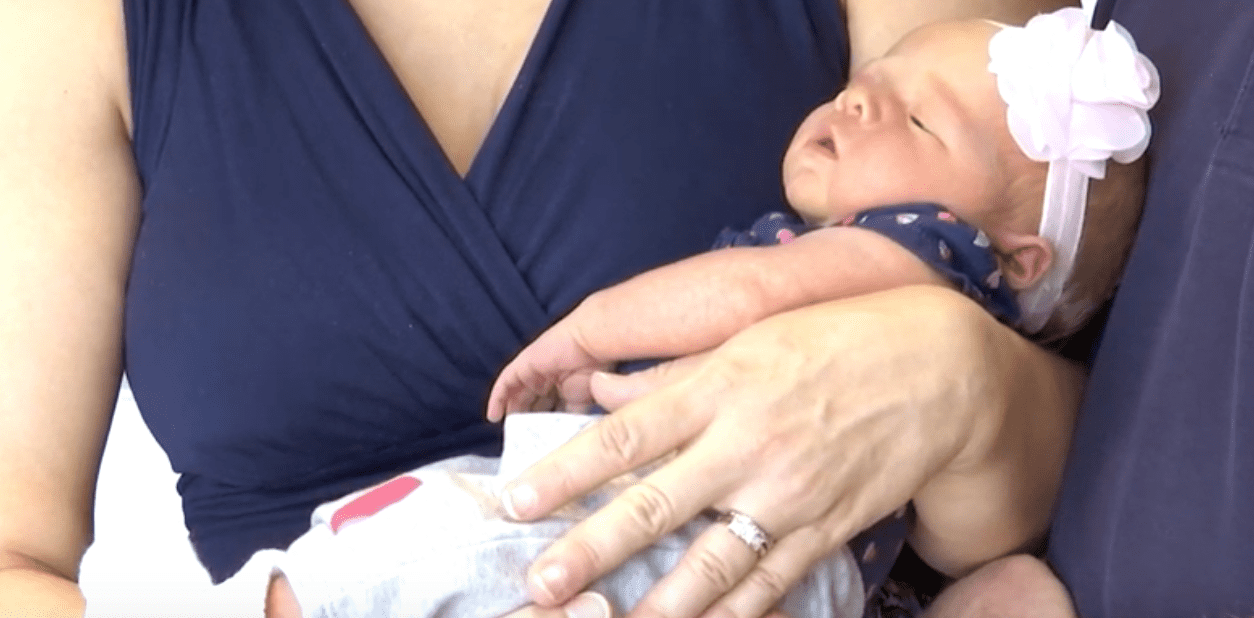 Kristina holding her baby girl. | Source: YouTube/WSAV3