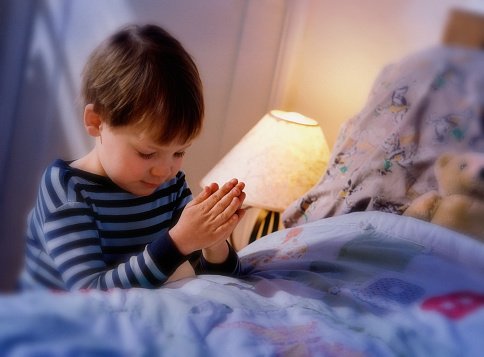 Photo of a young boy praying before going to bed | Photo: Getty Images