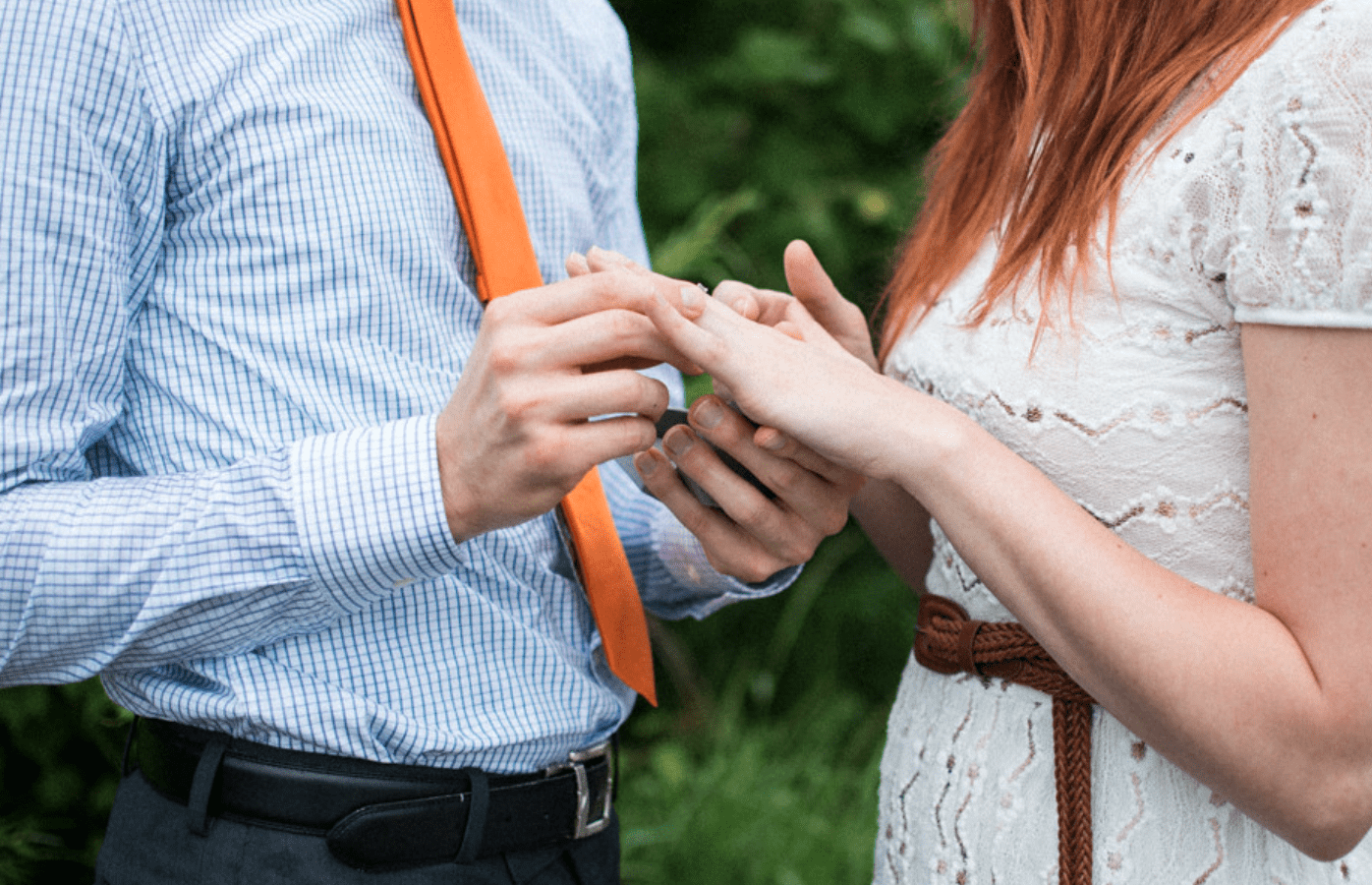A man places an engagement ring on a woman's finger. | Source: Flickr/Meredith McBride