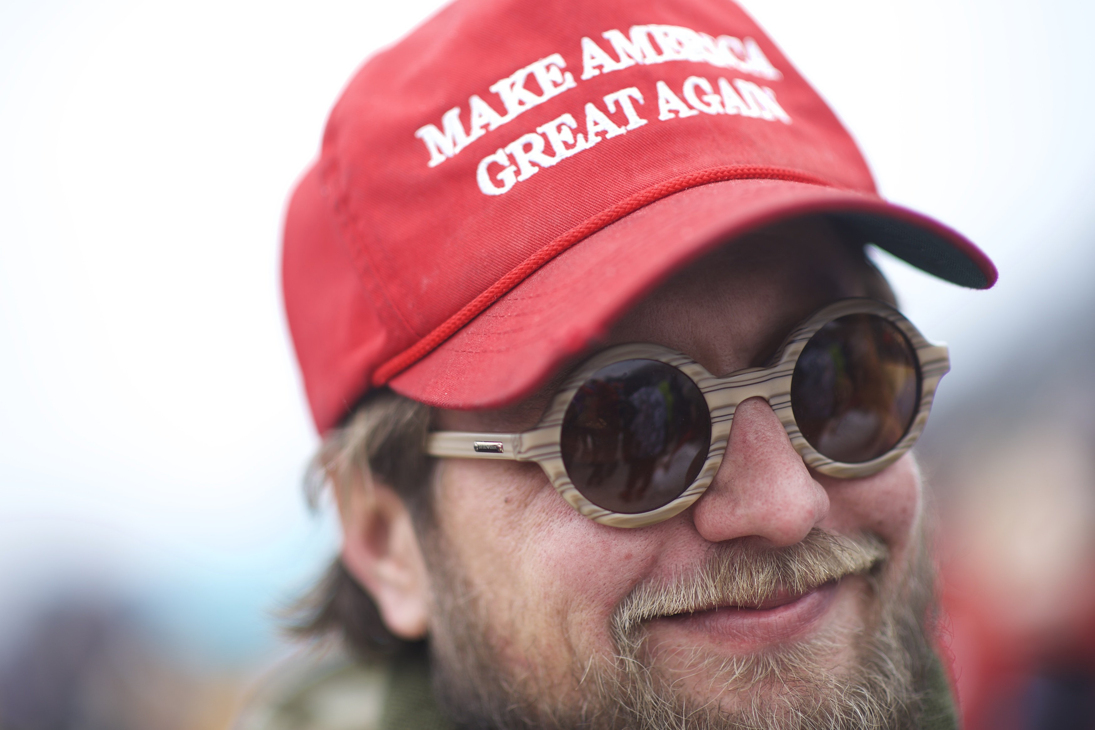 A Trump supporter wearing a MAGA hat | Photo: Getty Images