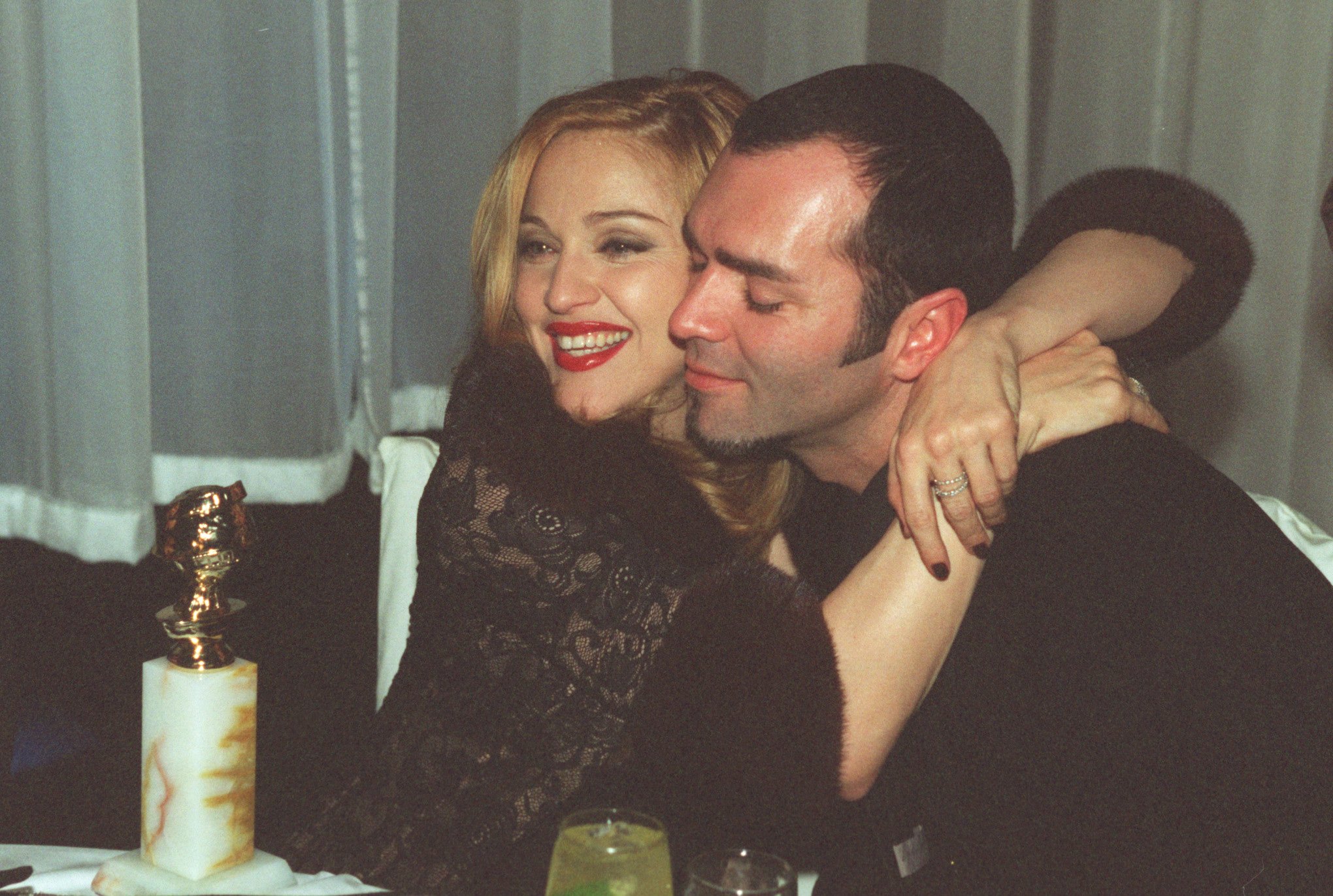 Madonna, winner of Golden Globe for Best Actress in Motion Picture Musical or Comedy with her brother Christopher Ciccone at the Disney party | Photo: Getty Images